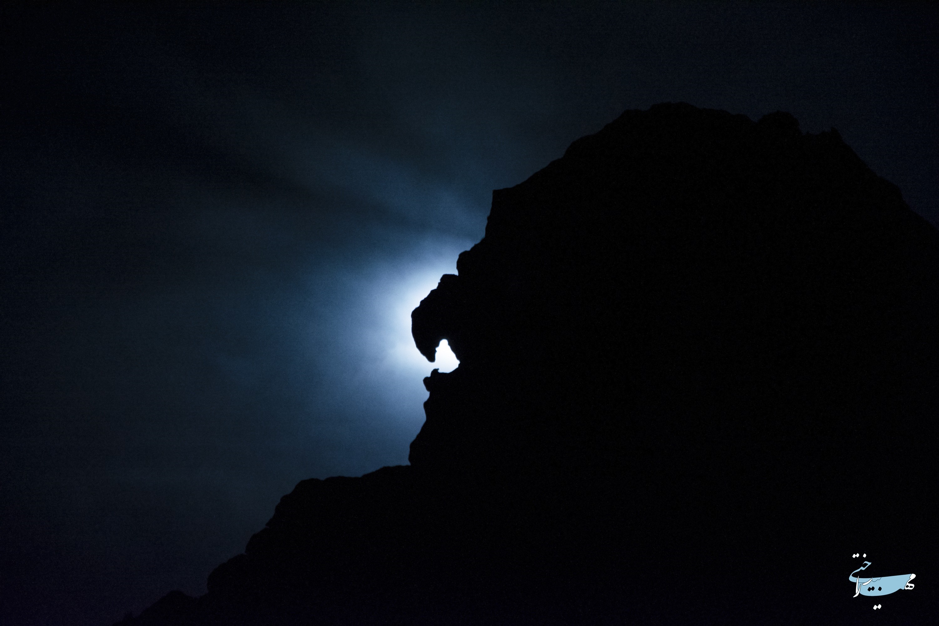 Silhouette of a mountain against the moonlit sky HD Wallpaper