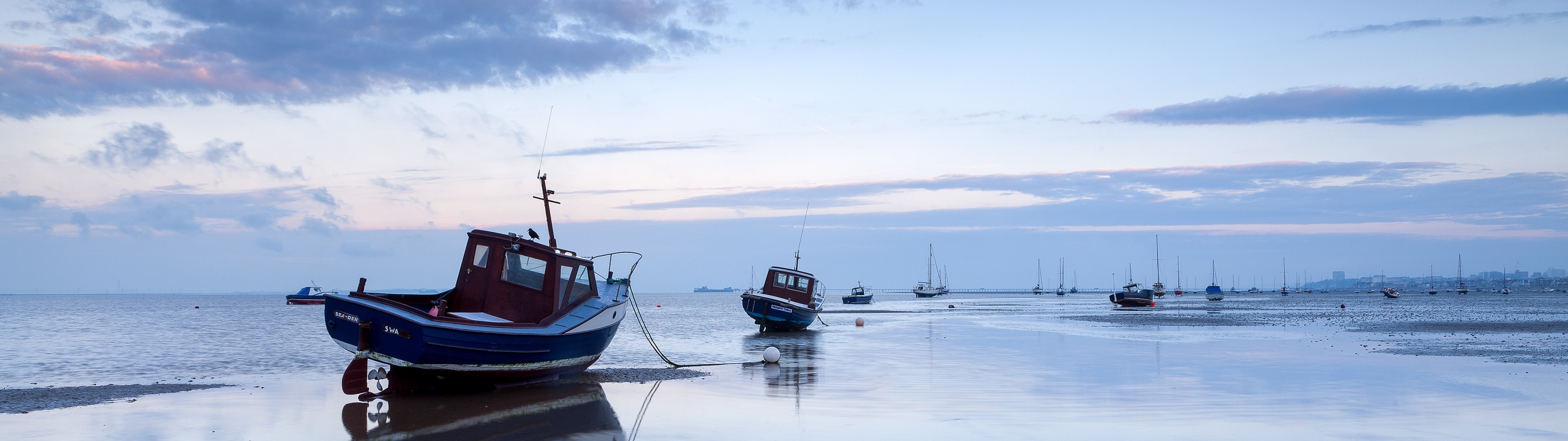 Boats moored on a calm sea at dusk HD Wallpaper