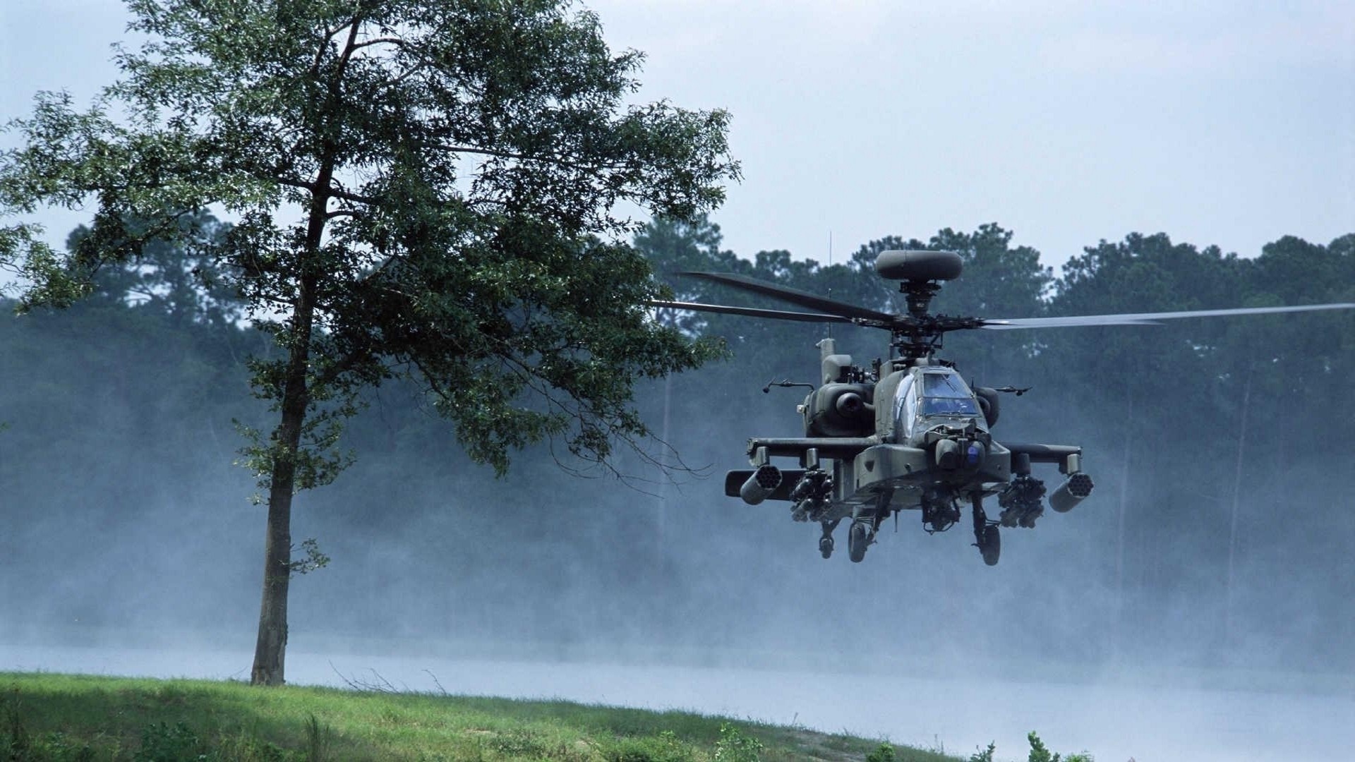 AH-64 Apache helicopter flying over misty water HD Wallpaper