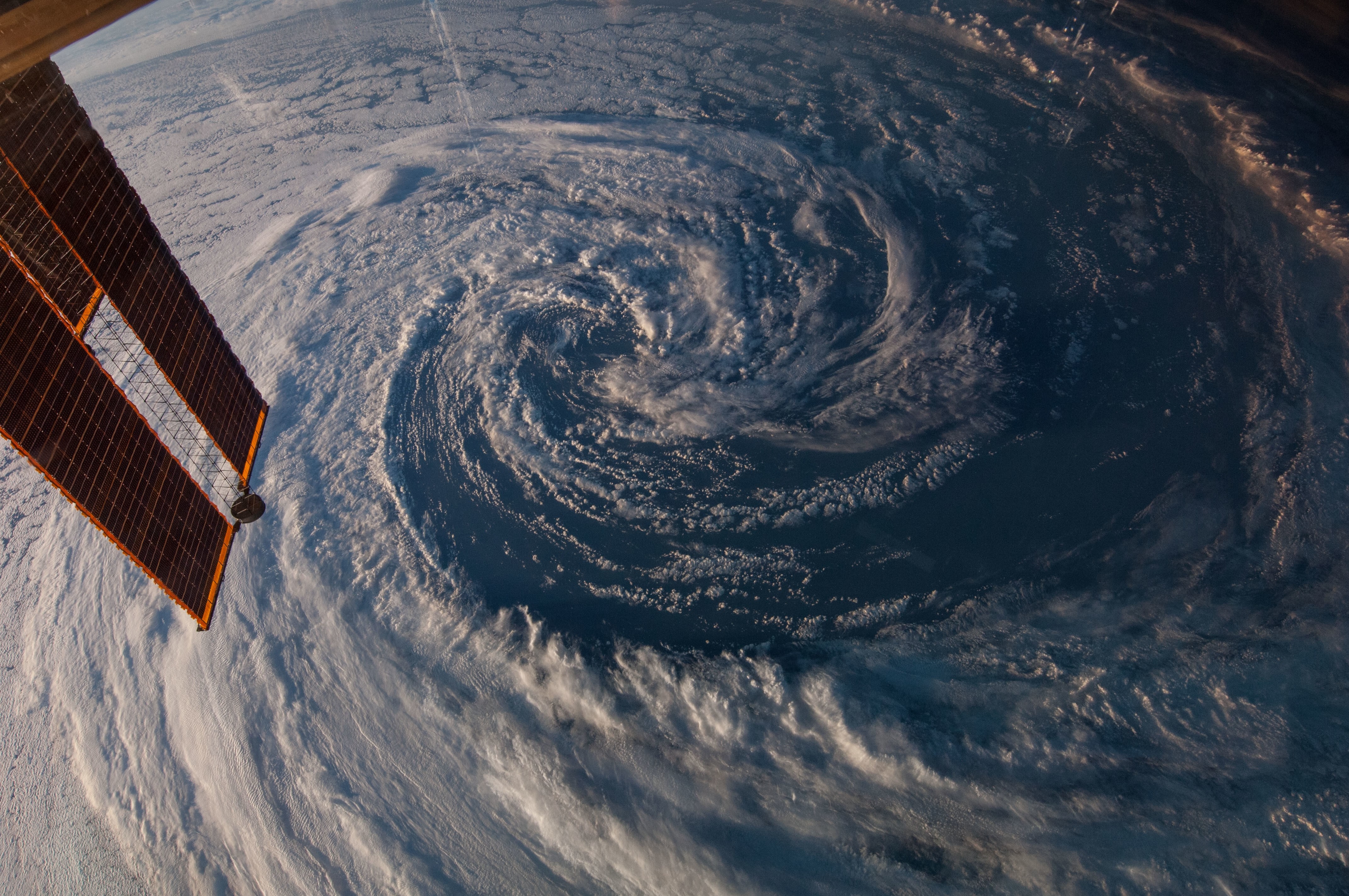 Hurricane viewed from space with solar panels HD Wallpaper