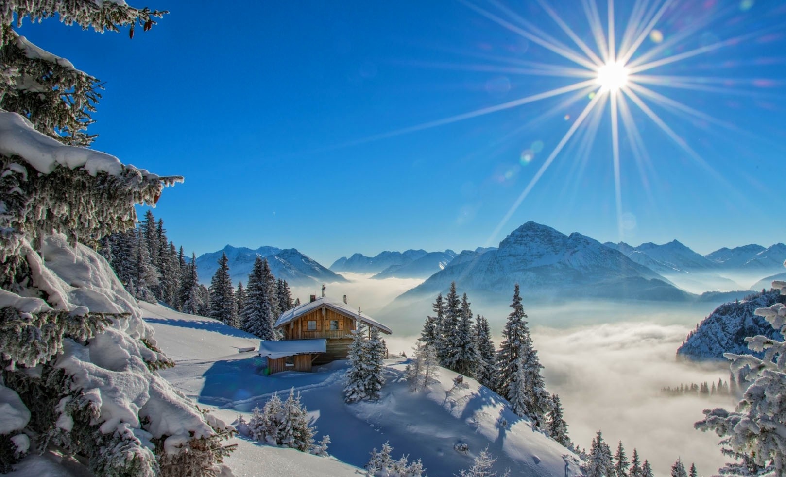 Snowy mountain landscape with a cabin and sun rays HD Wallpaper