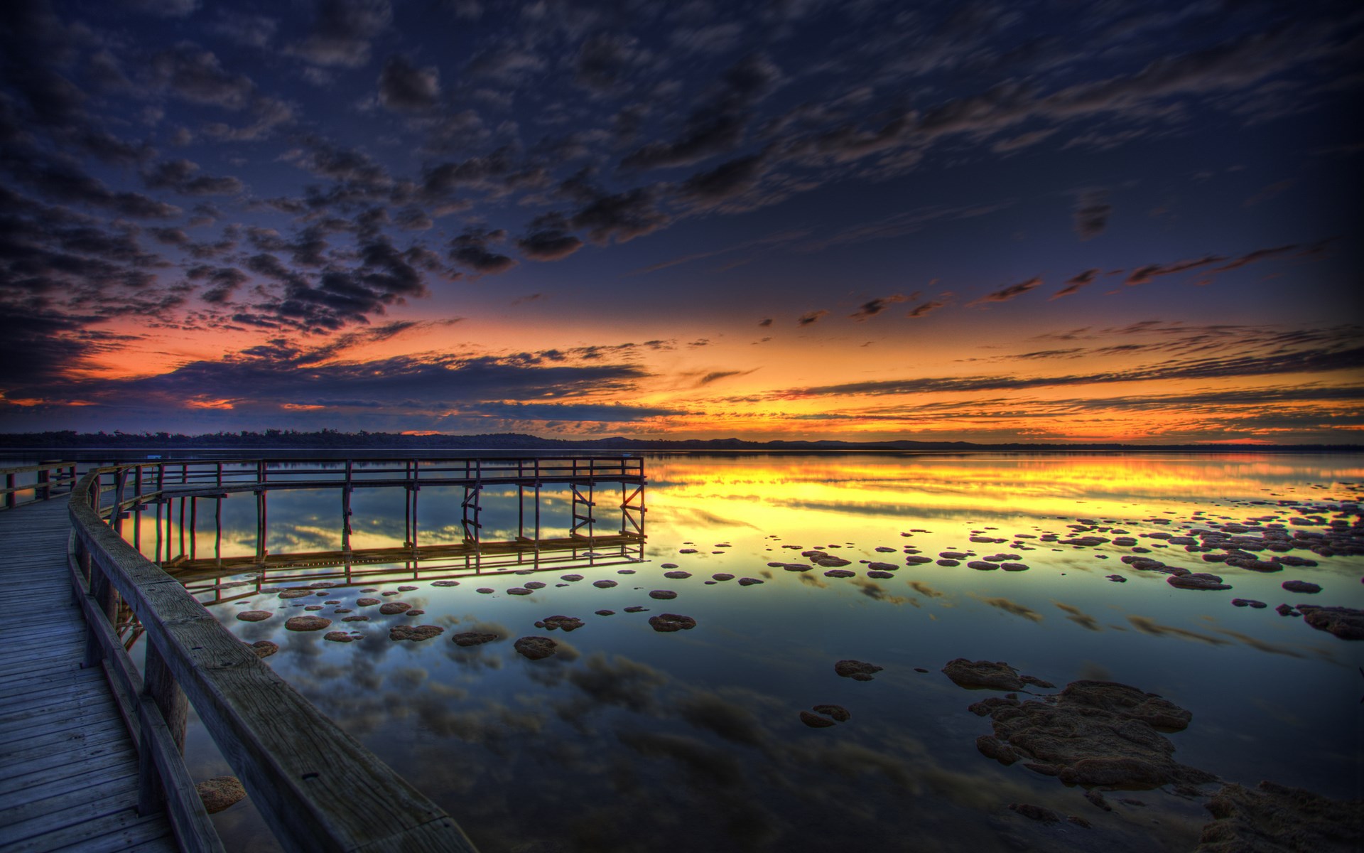Wooden boardwalk and pier over calm water at sunset HD Wallpaper