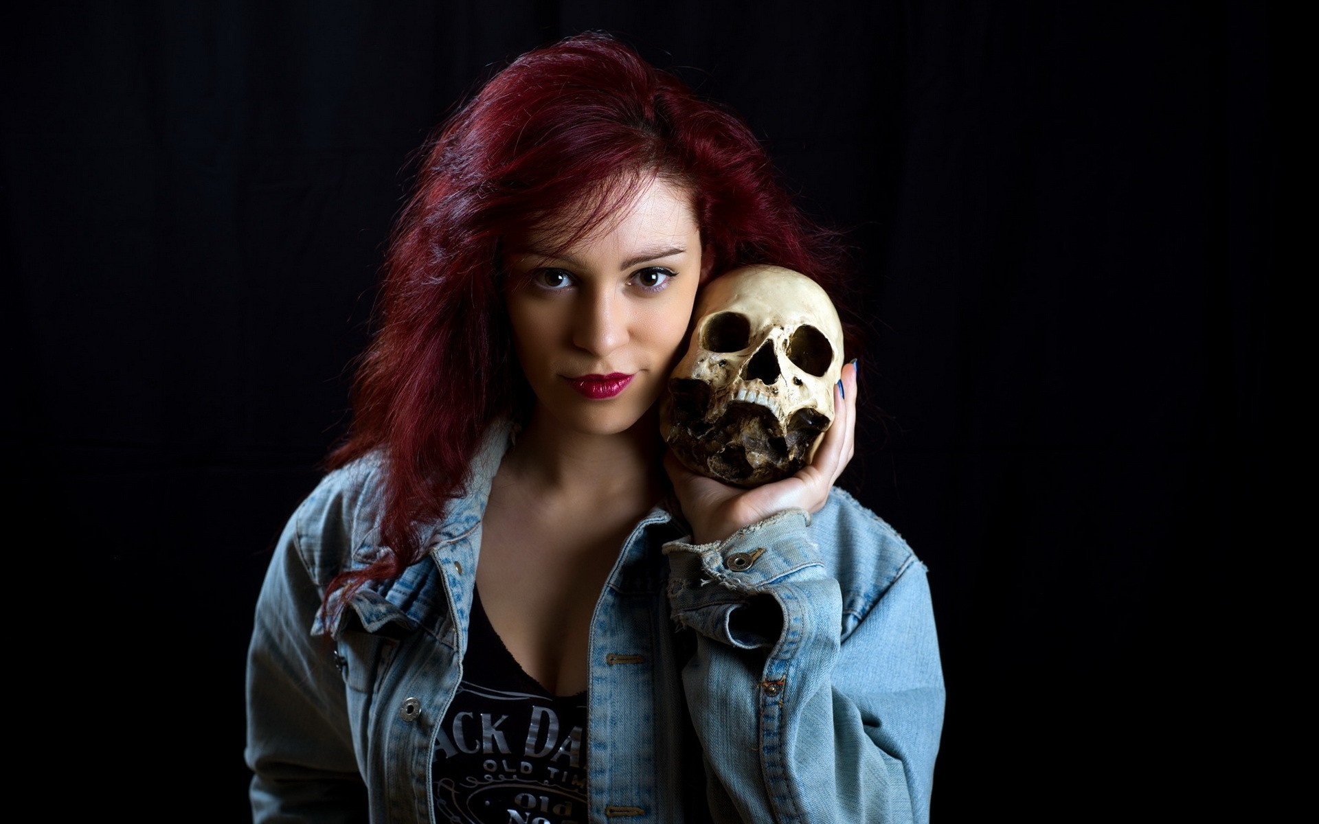 Woman with red hair holding a skull HD Wallpaper