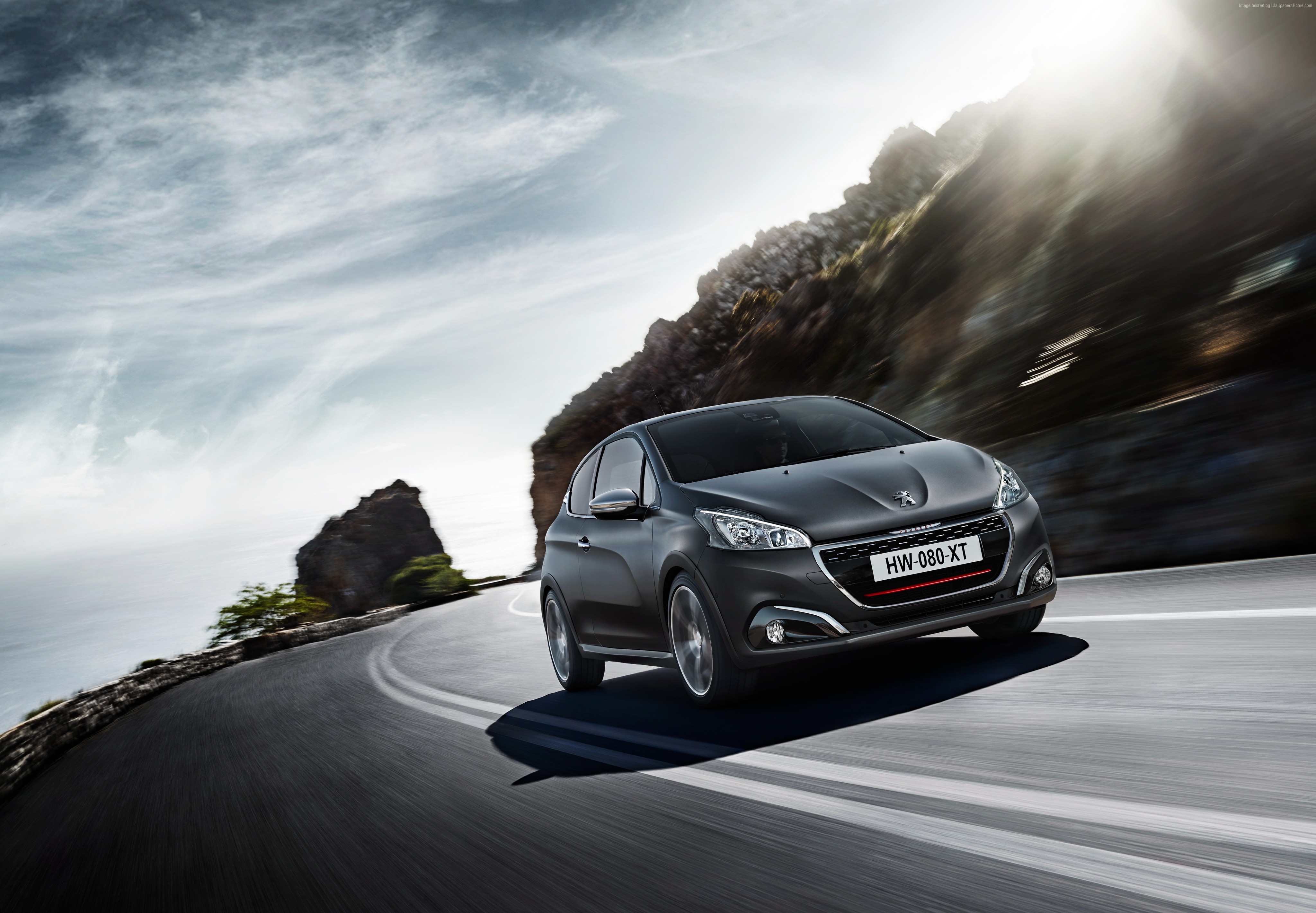 Gray Peugeot 208 GTI driving on a coastal road HD Wallpaper