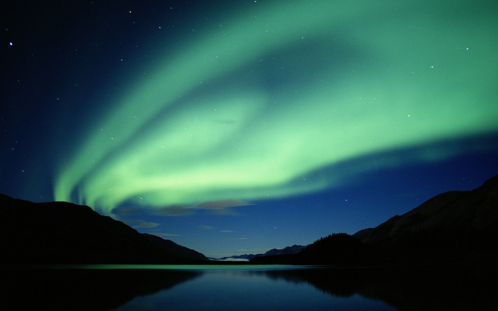 Aurora Borealis over a lake and mountains at night HD Wallpaper