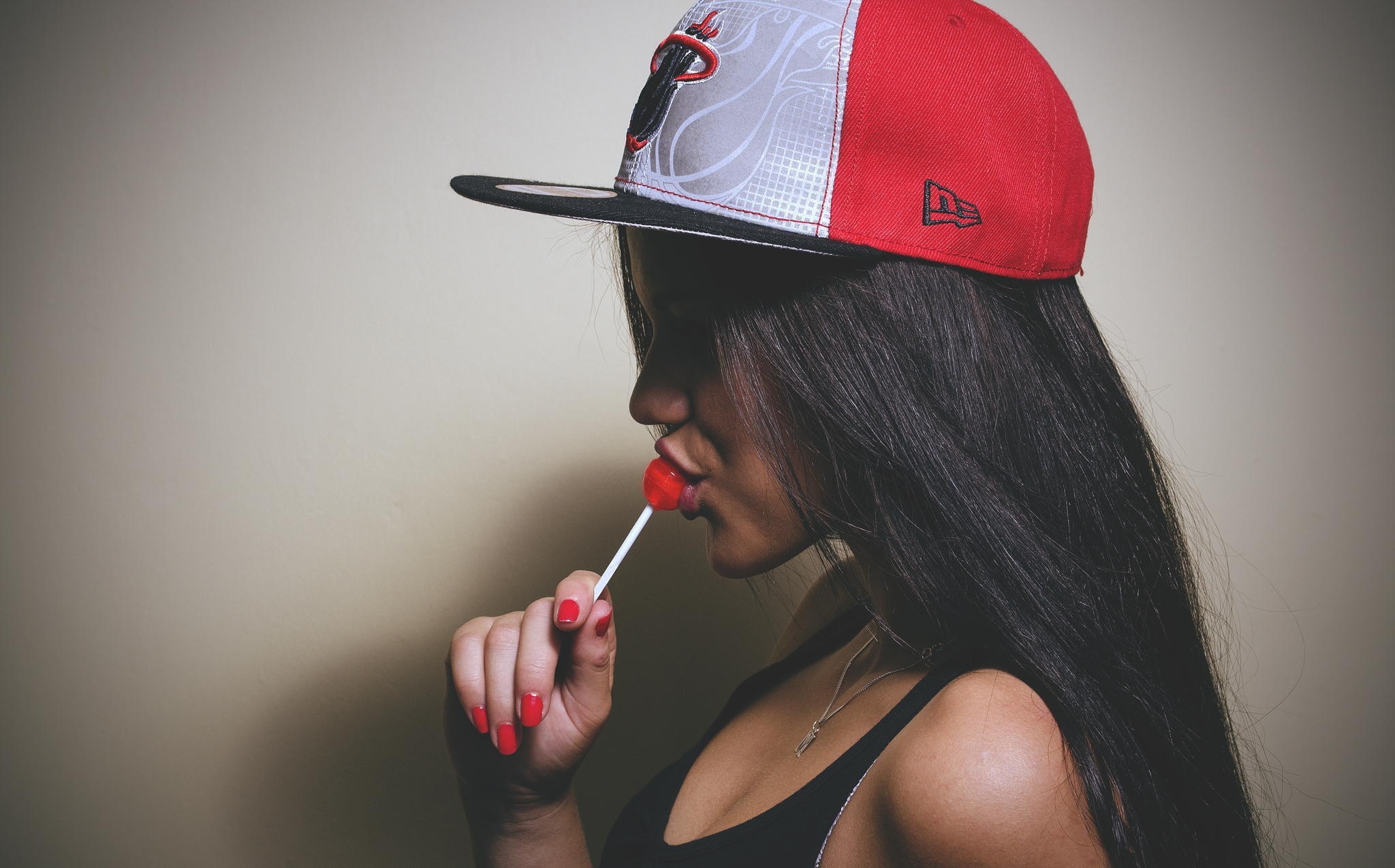 Woman in Red and Gray Cap Eating Lollipop HD Wallpaper