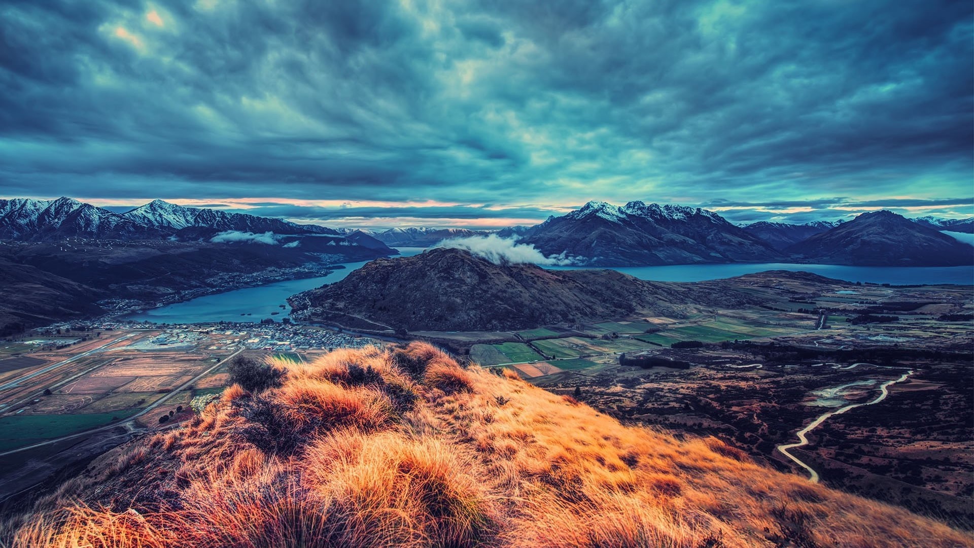 Aerial view of mountains and a lake at dawn HD Wallpaper