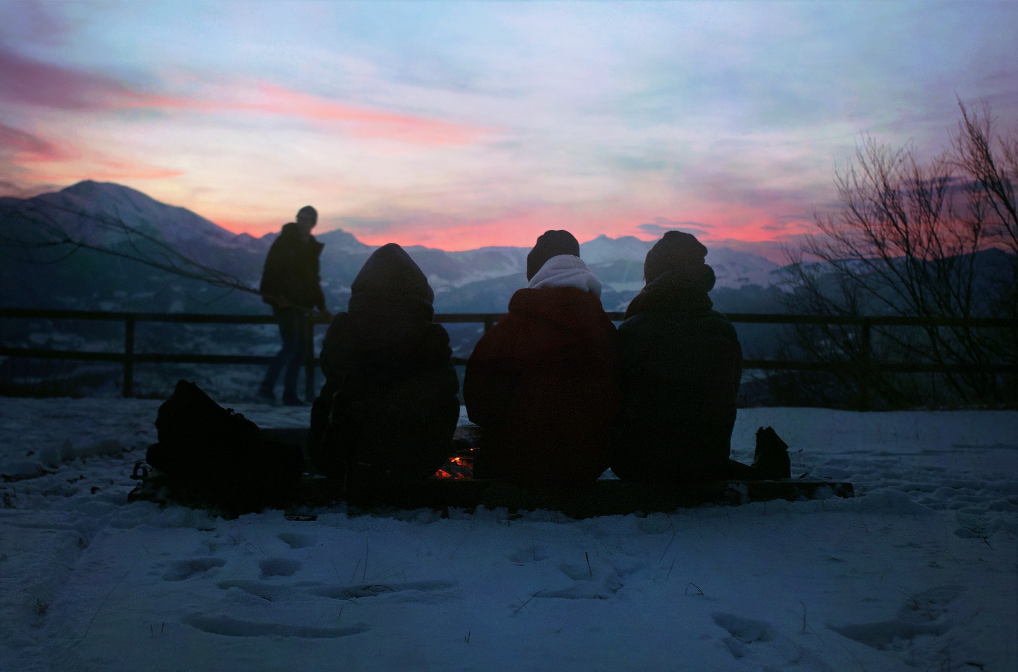 People watching sunset over snowy mountains HD Wallpaper
