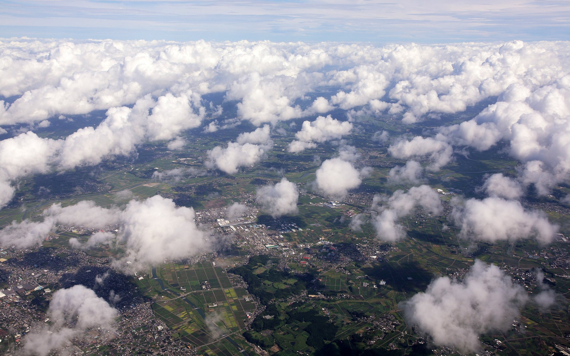 Aerial view of clouds over a landscape HD Wallpaper
