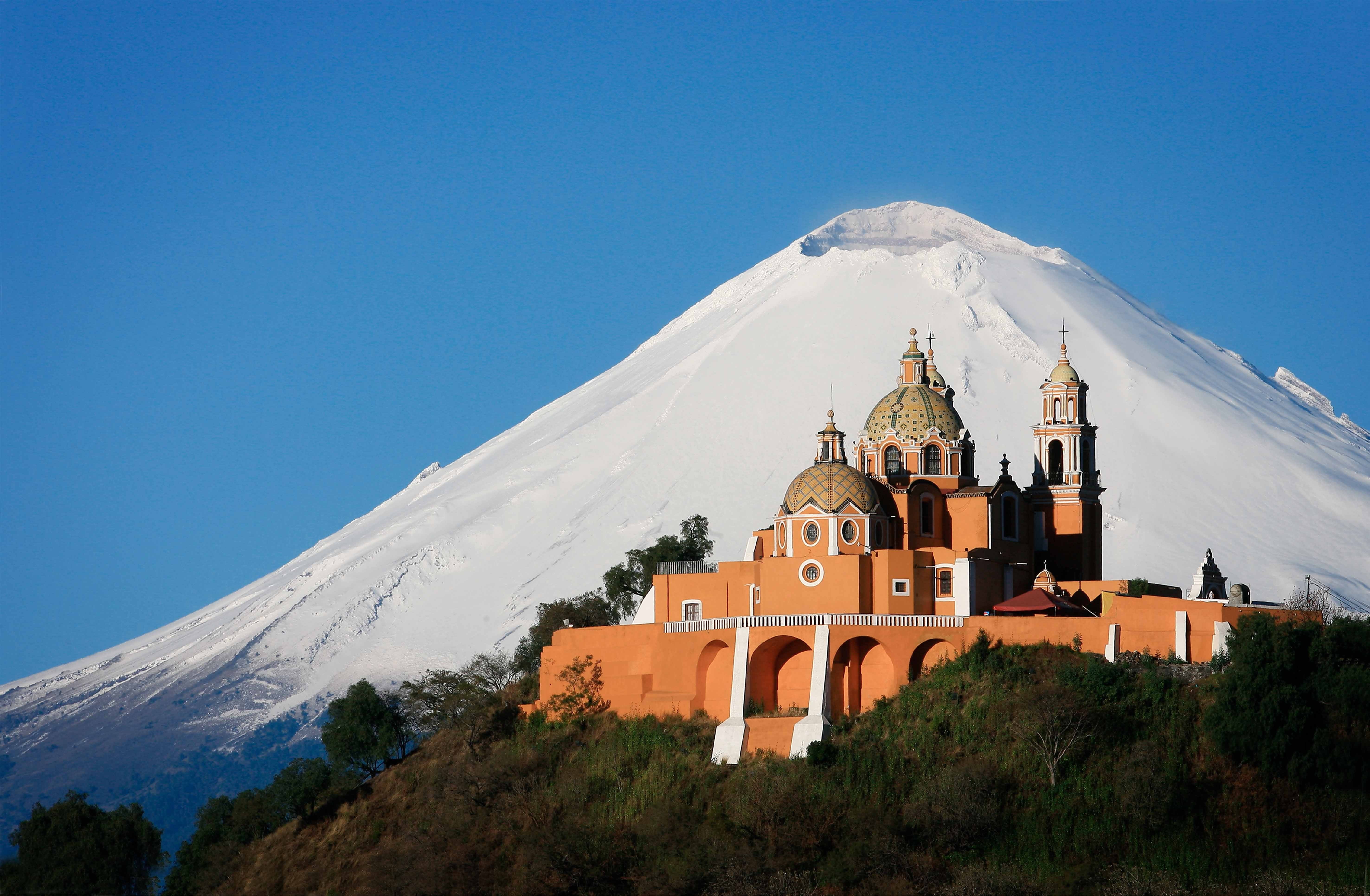 Church on a hill with Pico de Orizaba volcano in the background HD Wallpaper