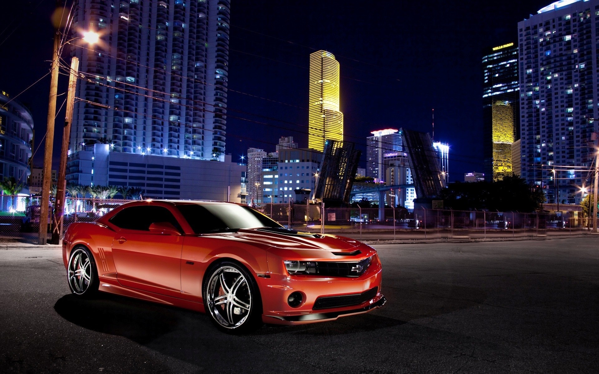 Red Chevrolet Camaro parked in a city at night HD Wallpaper