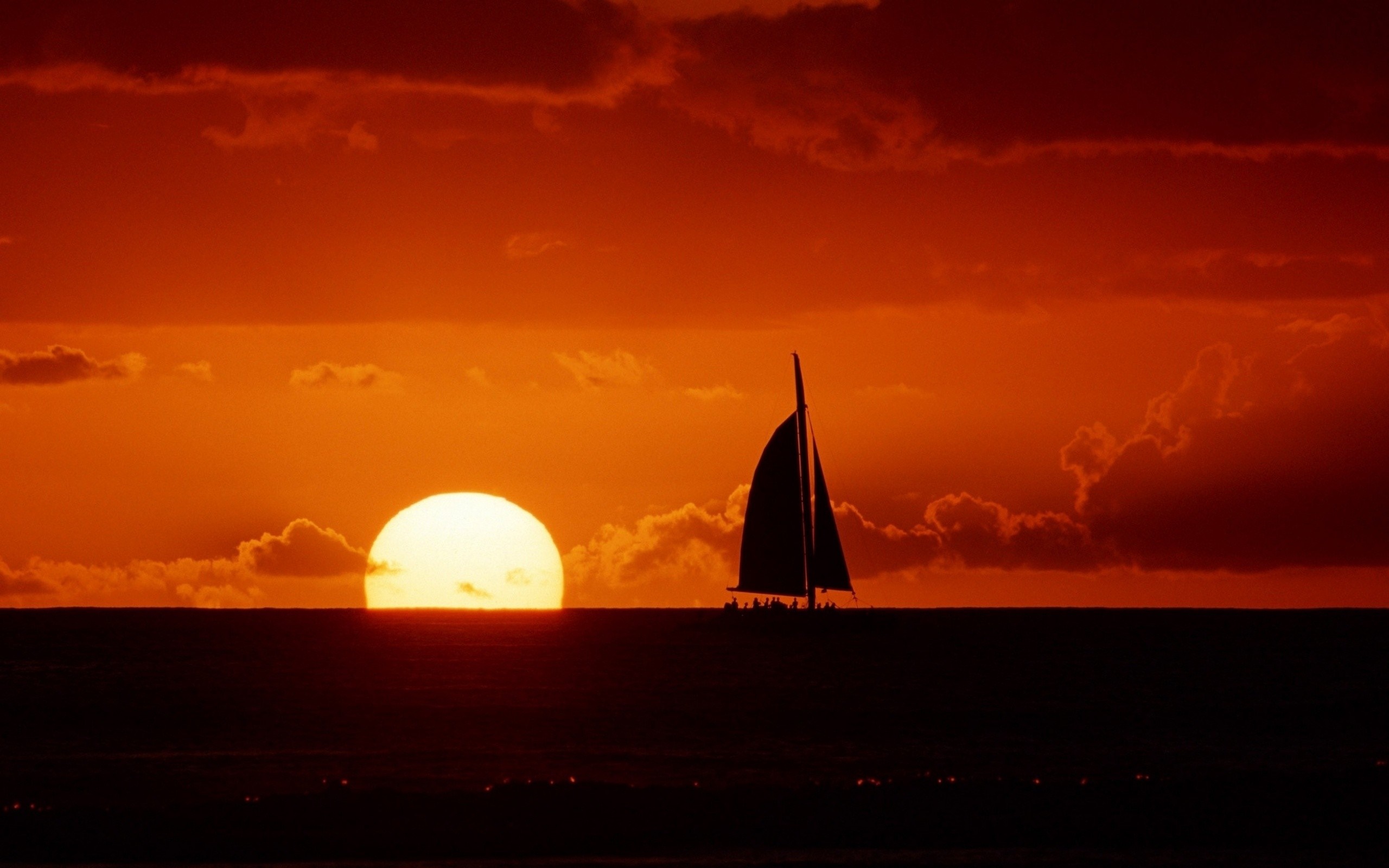 Sailboat on the horizon at sunset HD Wallpaper