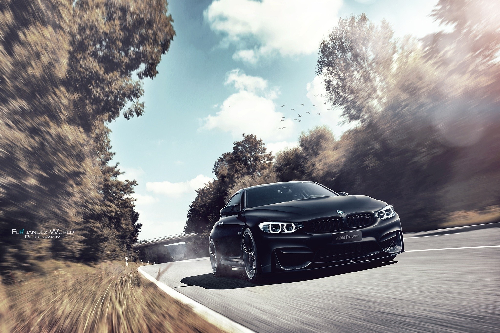 Black BMW M4 driving on a road with motion blur HD Wallpaper
