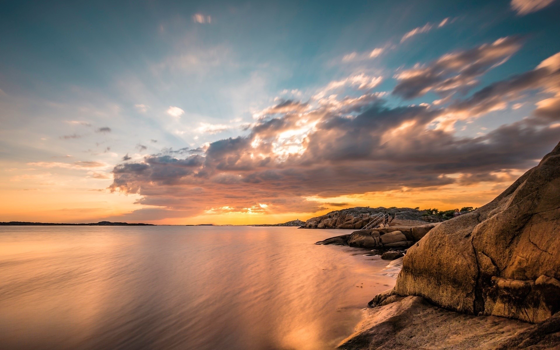 Sunset over rocky coast with calm water HD Wallpaper