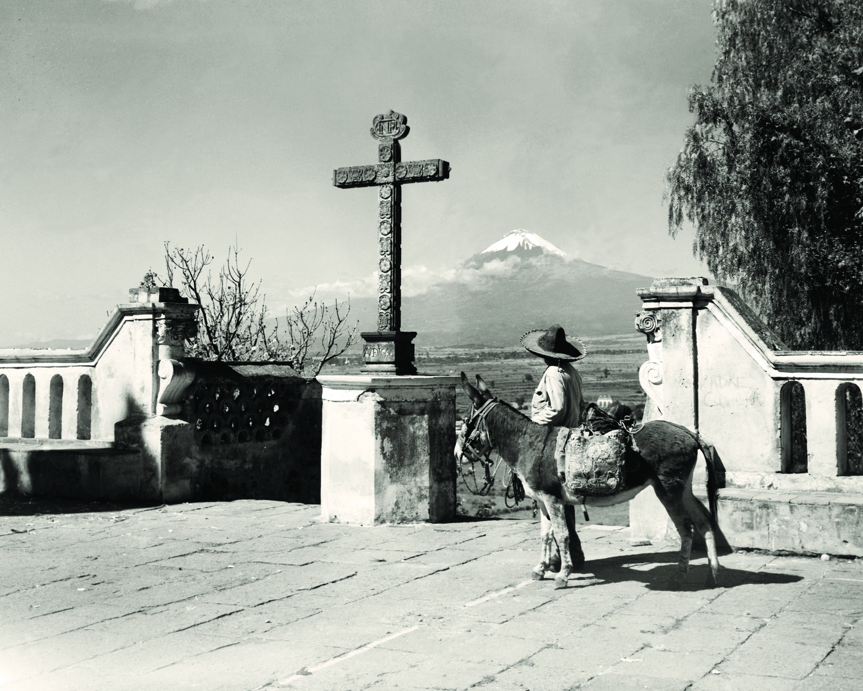 Man with donkey and cross before volcano HD Wallpaper