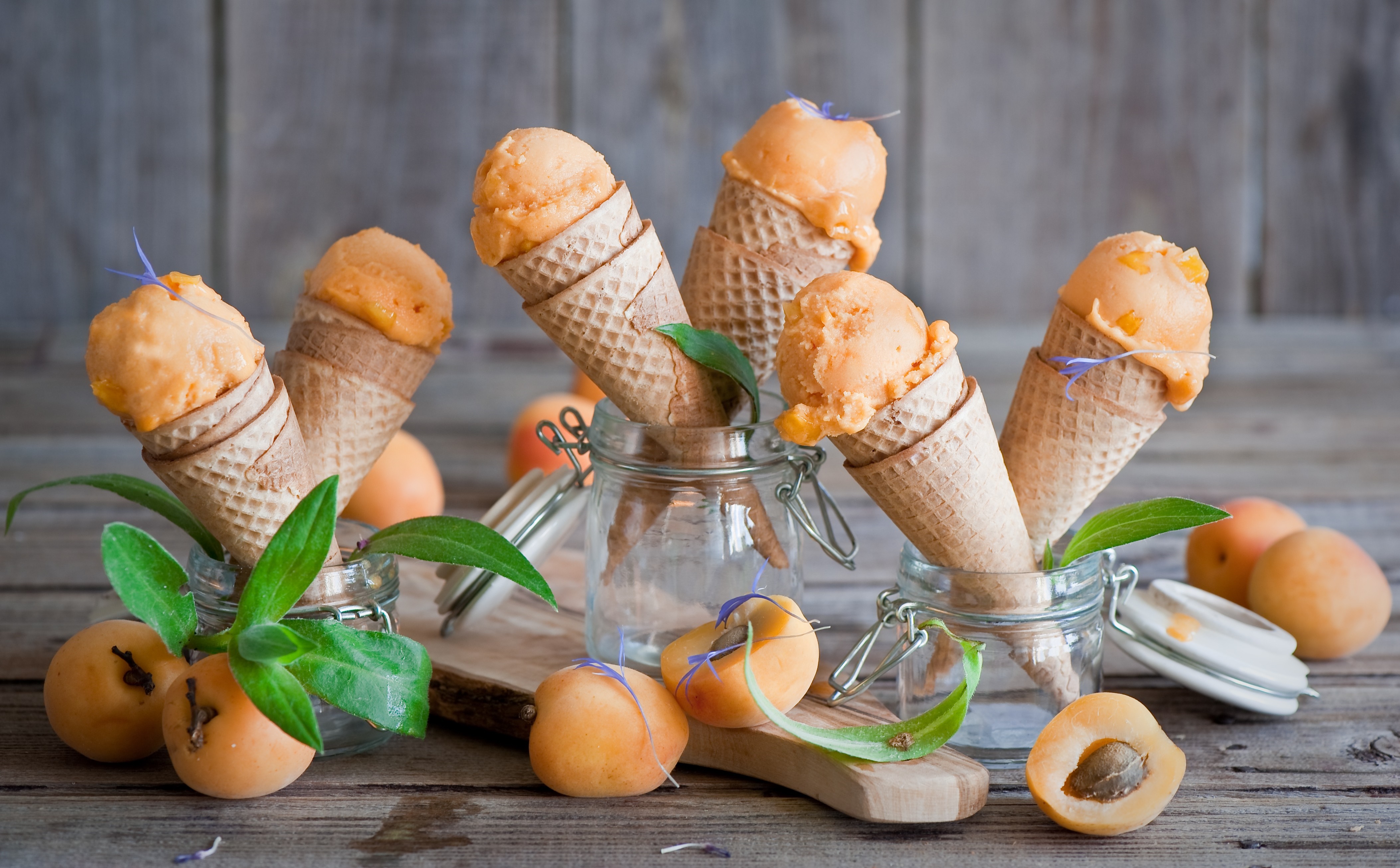 Orange ice cream cones with apricots and leaves HD Wallpaper