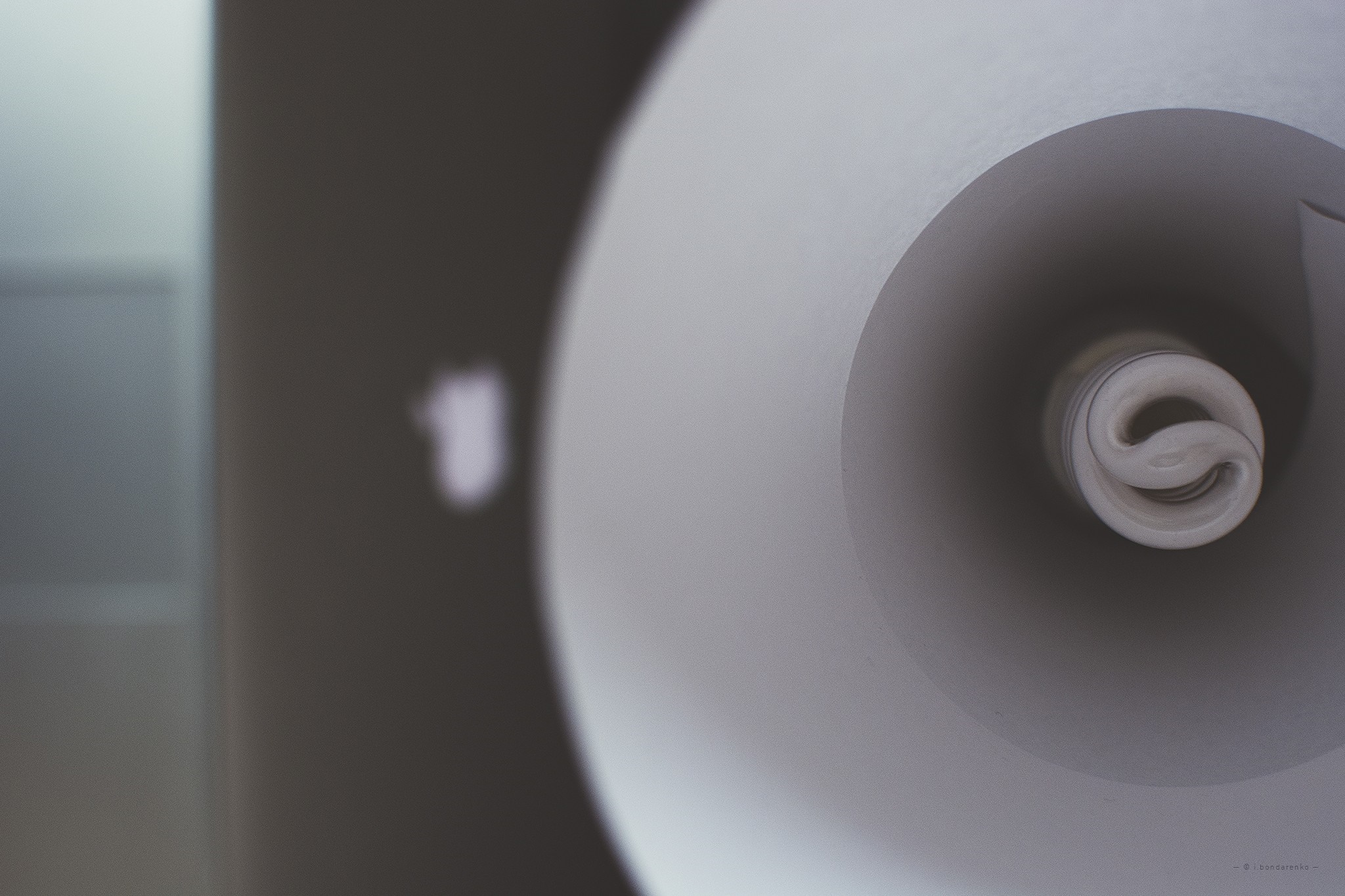 Close up of a spiral fluorescent light bulb HD Wallpaper