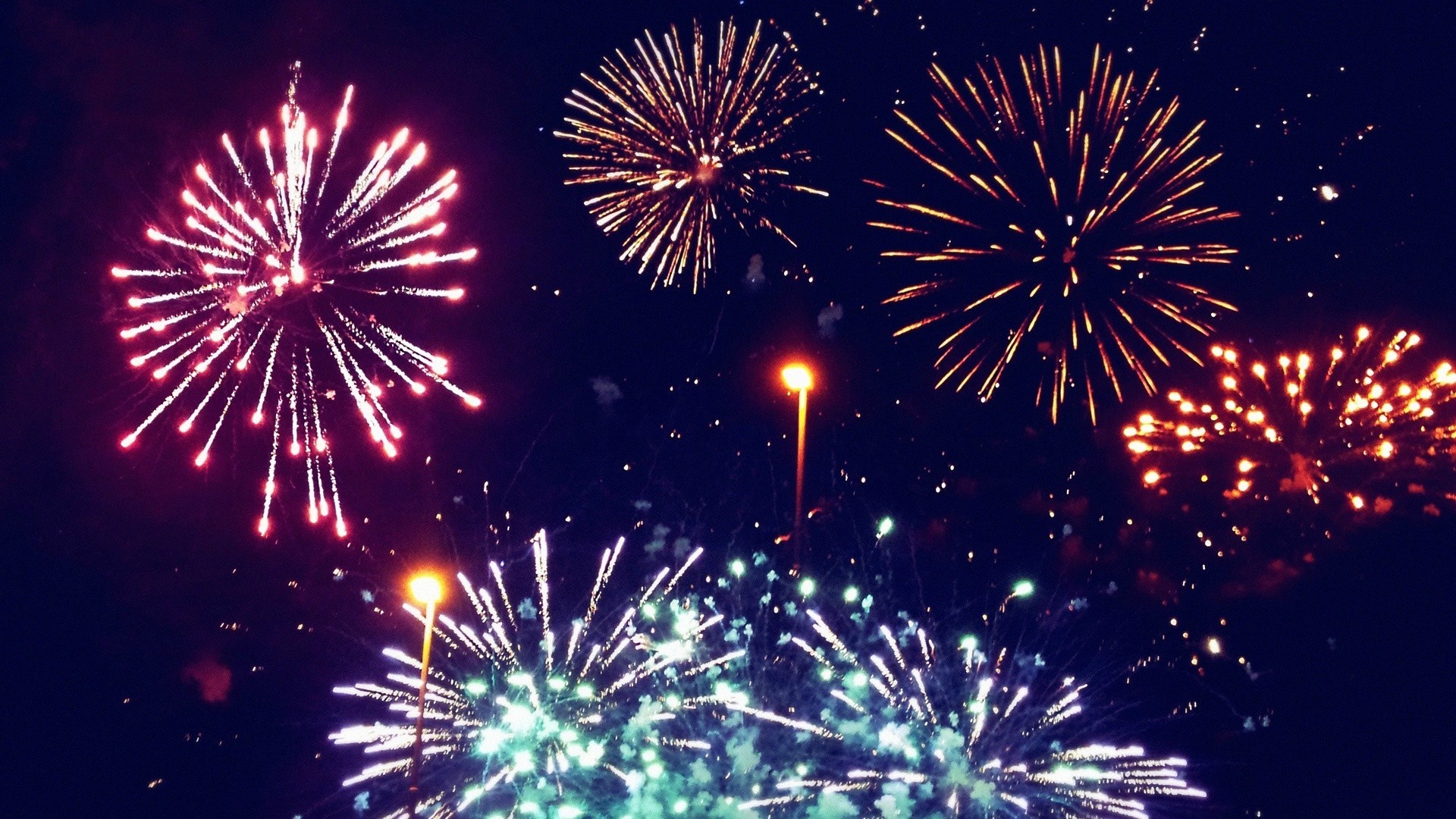 Fireworks exploding in the night sky HD Wallpaper