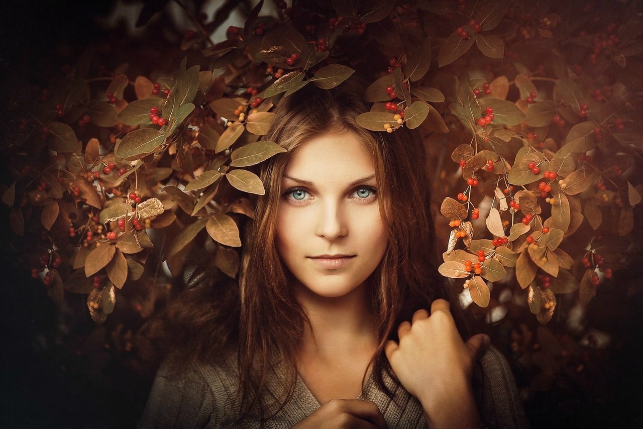 Woman with blue eyes surrounded by autumn leaves HD Wallpaper