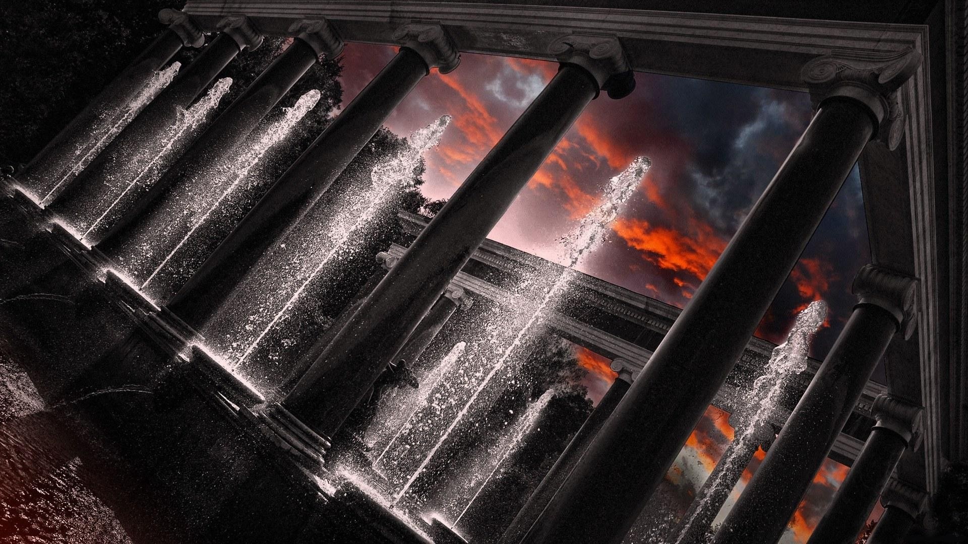 Columns and fountains against a dramatic sunset sky HD Wallpaper
