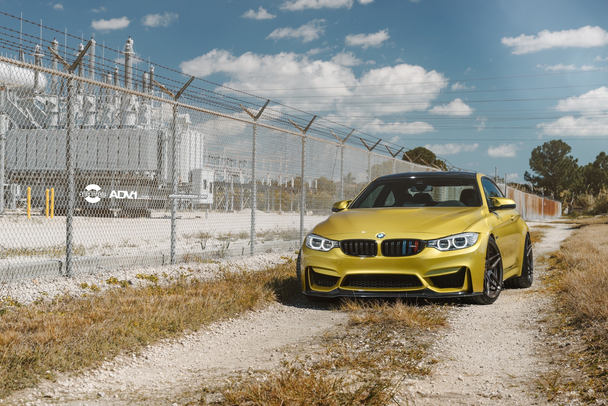 Yellow BMW M4 with ADV.1 Wheels near Power Station HD Wallpaper