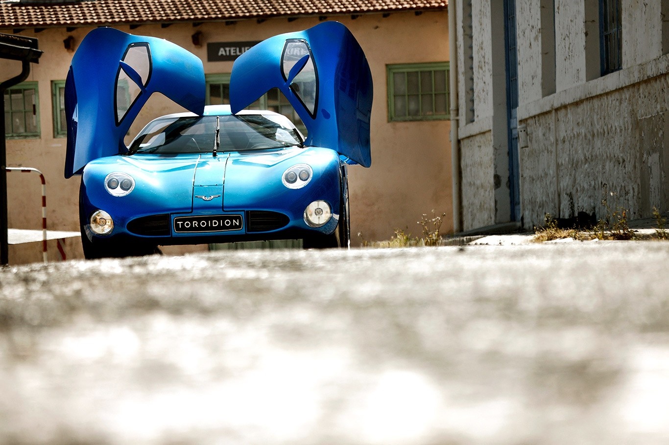 Blue Toroidion 1MW sports car with doors open HD Wallpaper