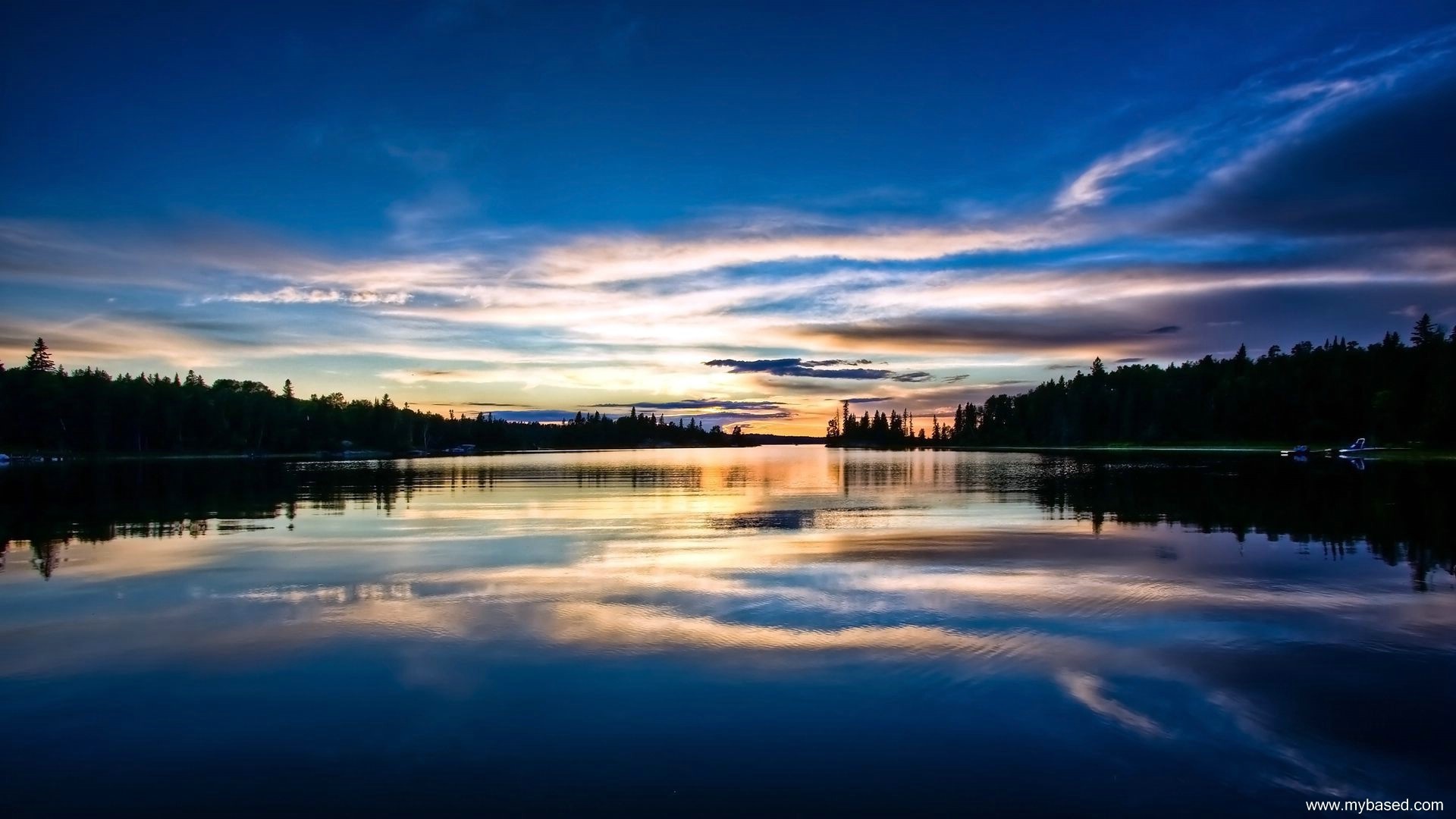 Sunset over a calm lake with reflections HD Wallpaper