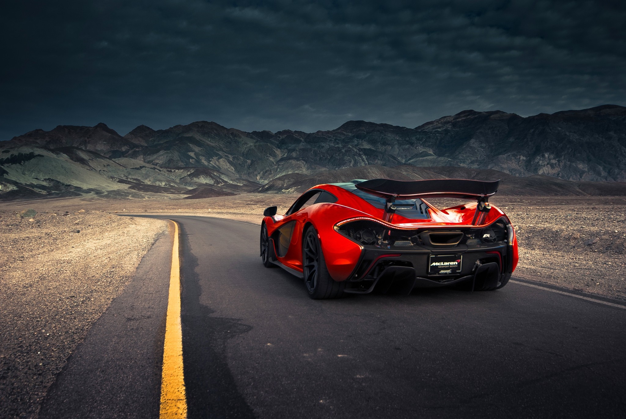Red McLaren P1 driving on a desert road HD Wallpaper