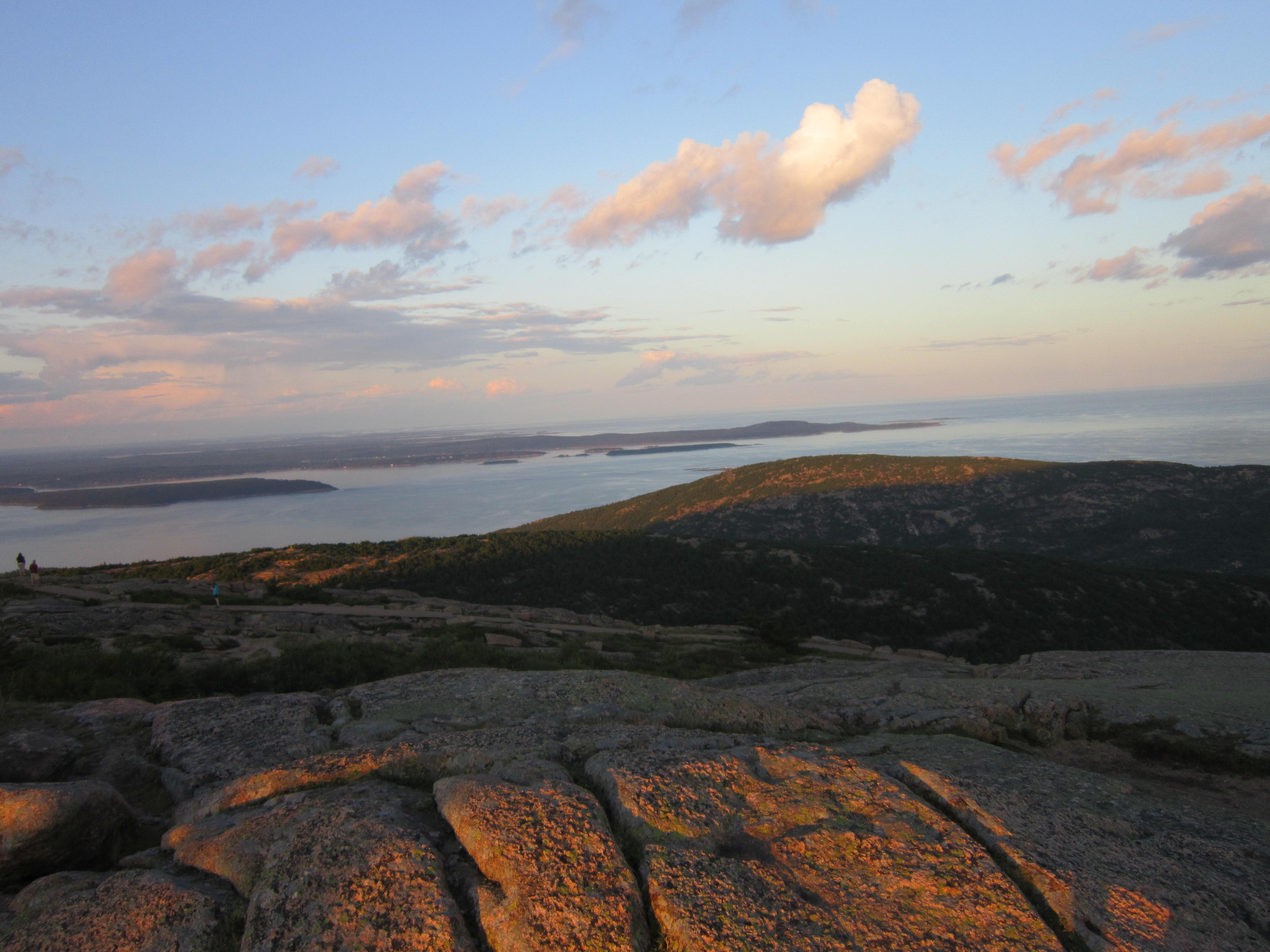Rocky summit overlooking a bay at sunset HD Wallpaper