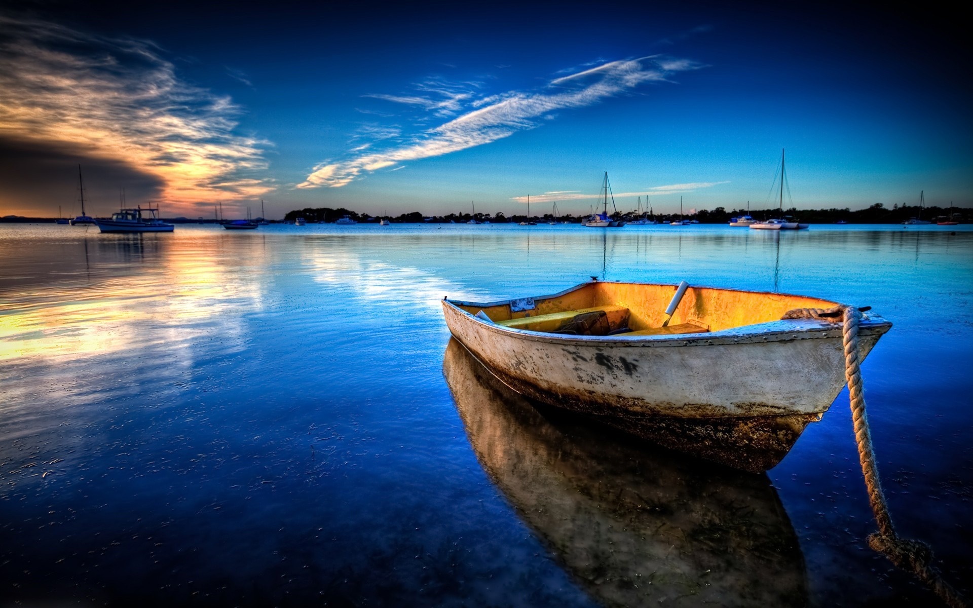 Boat on calm water at sunset with reflections HD Wallpaper
