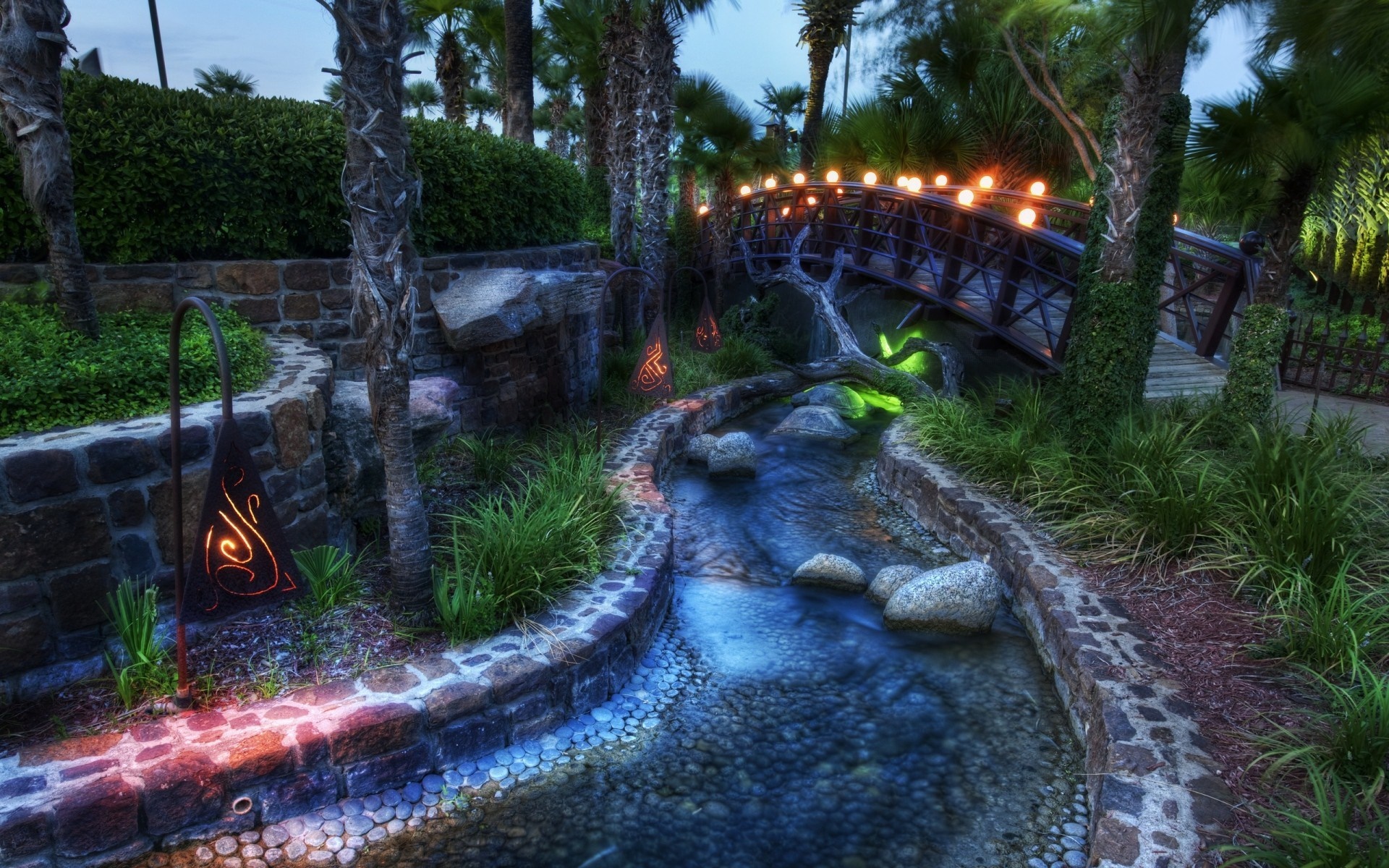 Garden with a stream and a bridge at dusk HD Wallpaper