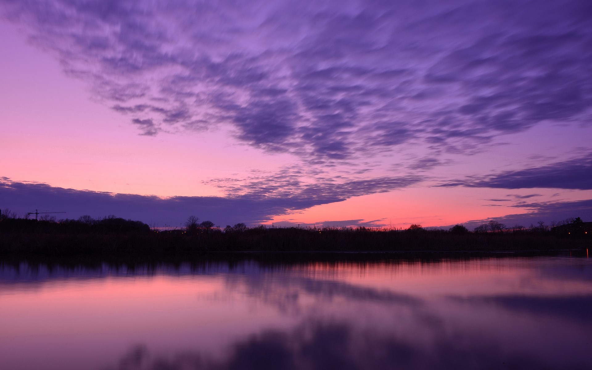 Purple sunset over a calm lake with reflections HD Wallpaper