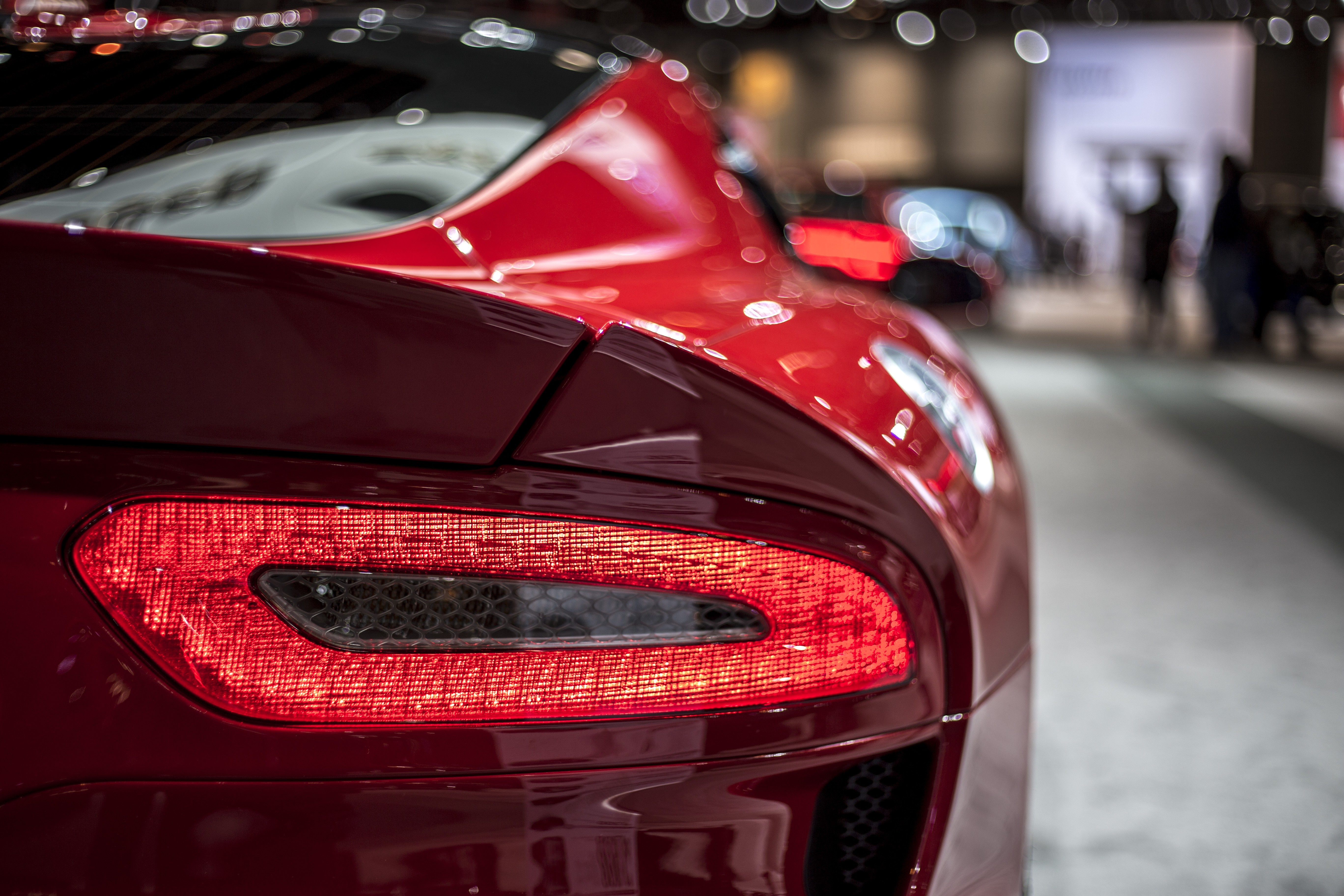 Close-up of a red SRT Viper's taillight at an auto show HD Wallpaper