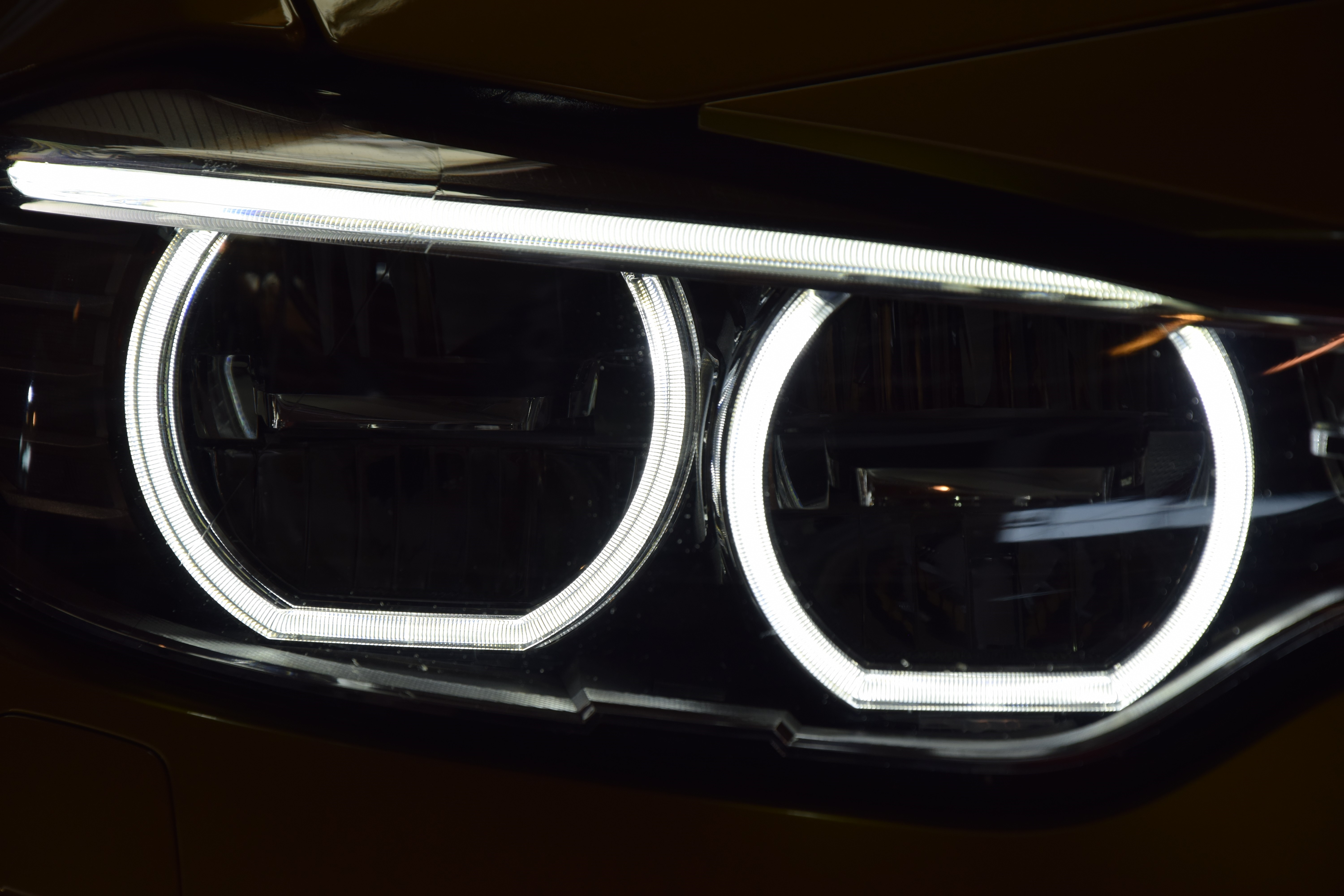 BMW M4 Coupe headlights with LED daytime running lights HD Wallpaper