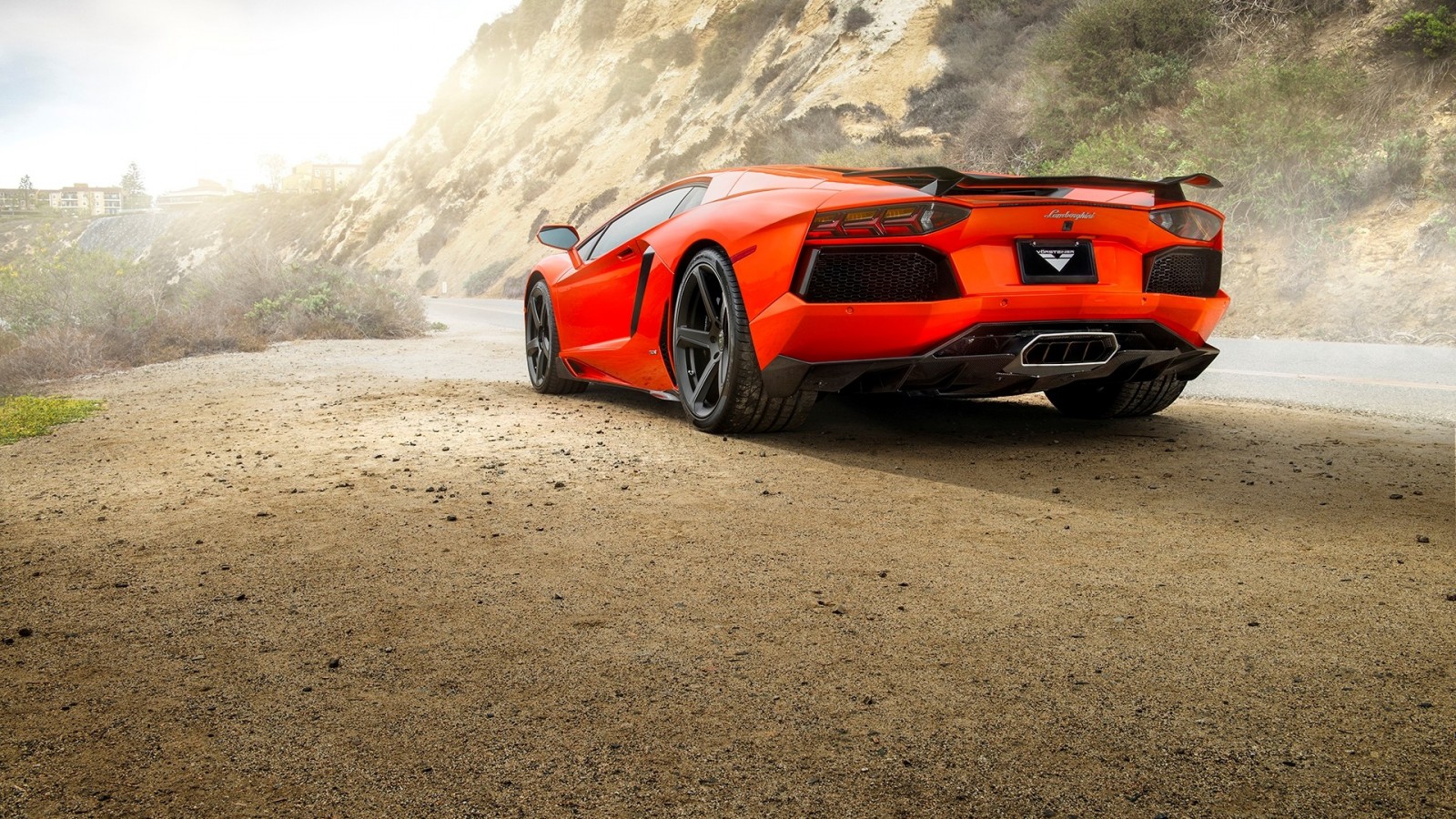 Orange Lamborghini Aventador parked on a dirt road HD Wallpaper