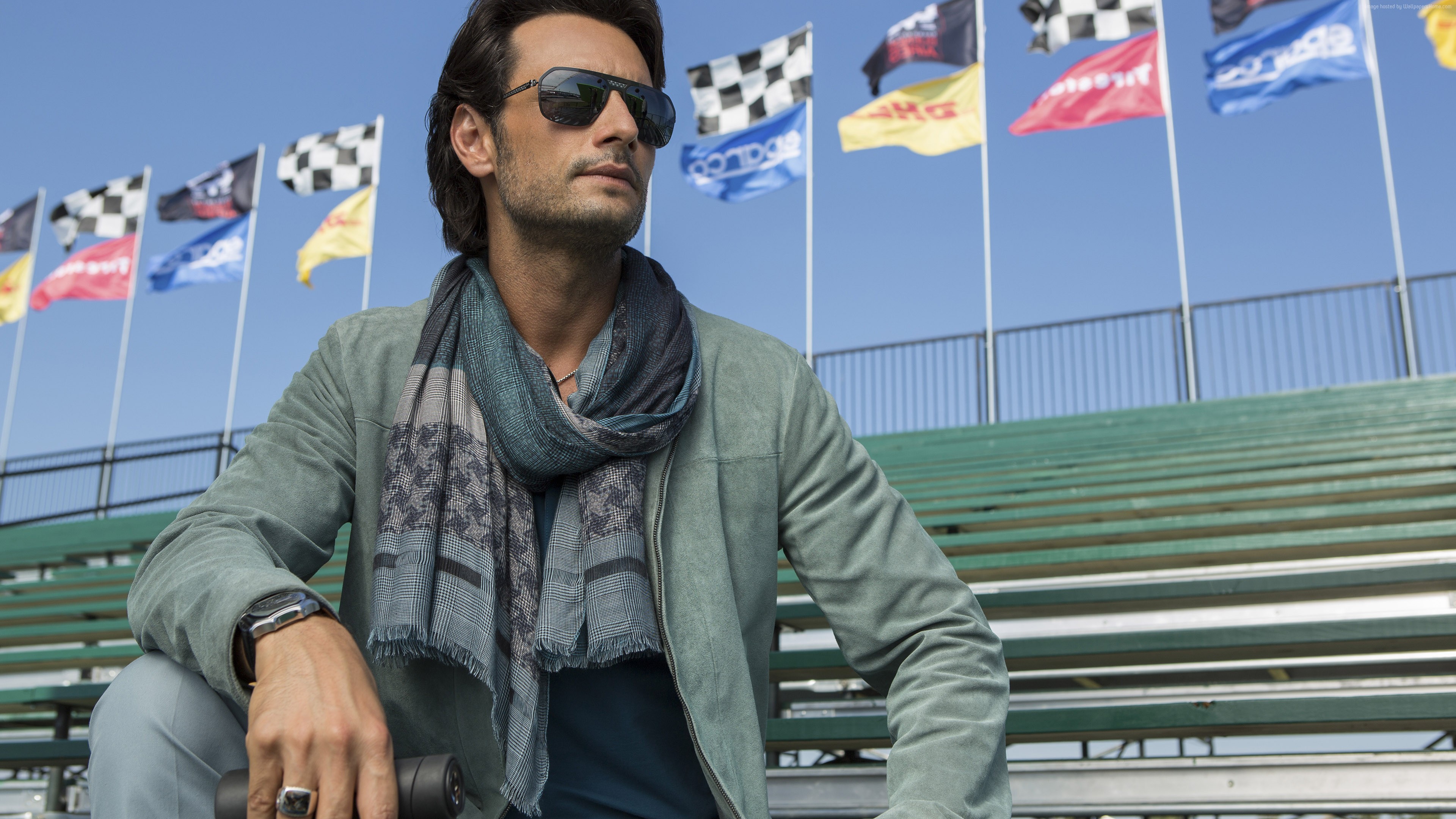 Rodrigo Santoro sitting on bleachers with flags HD Wallpaper