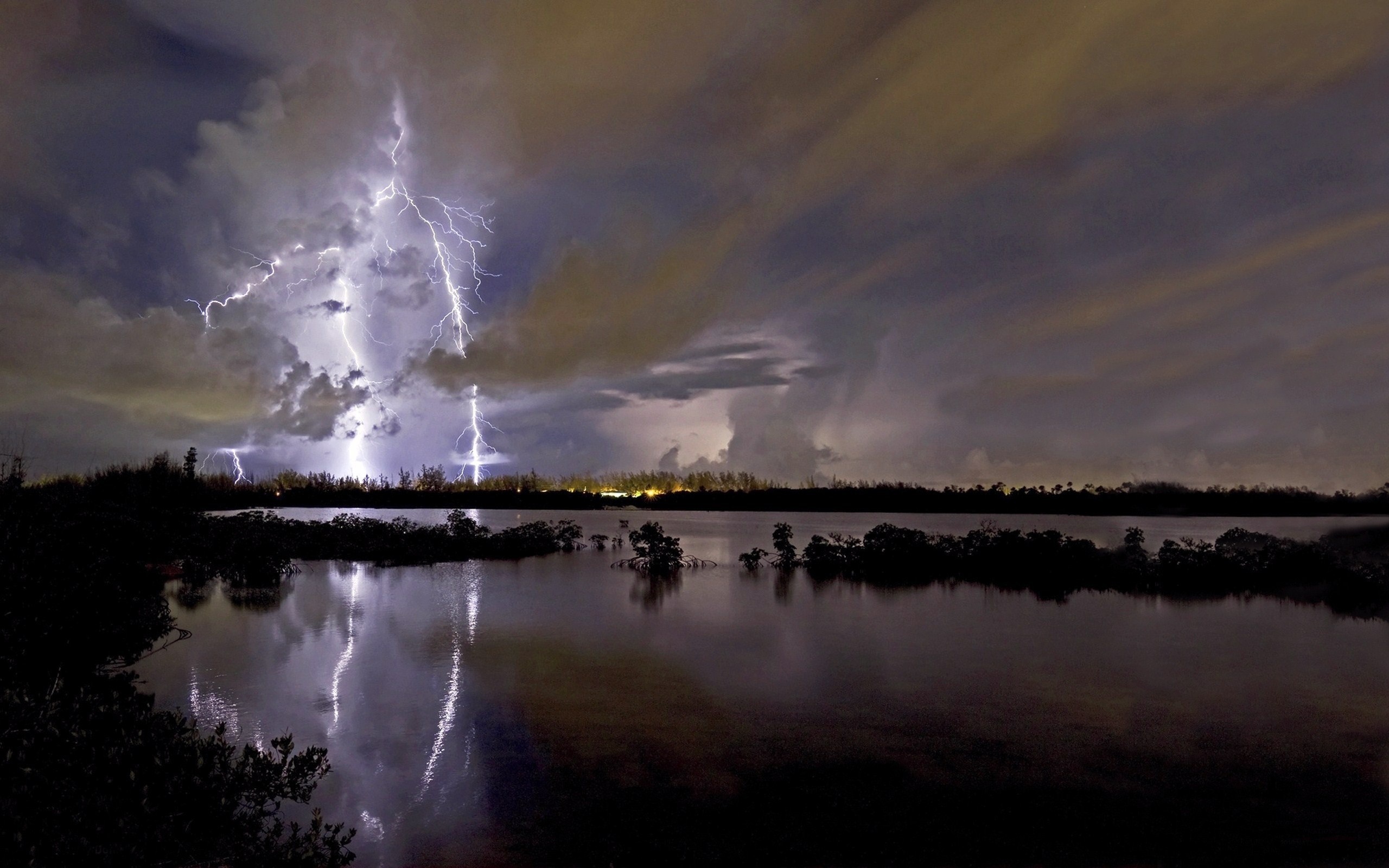 Lightning strikes over a lake at night HD Wallpaper
