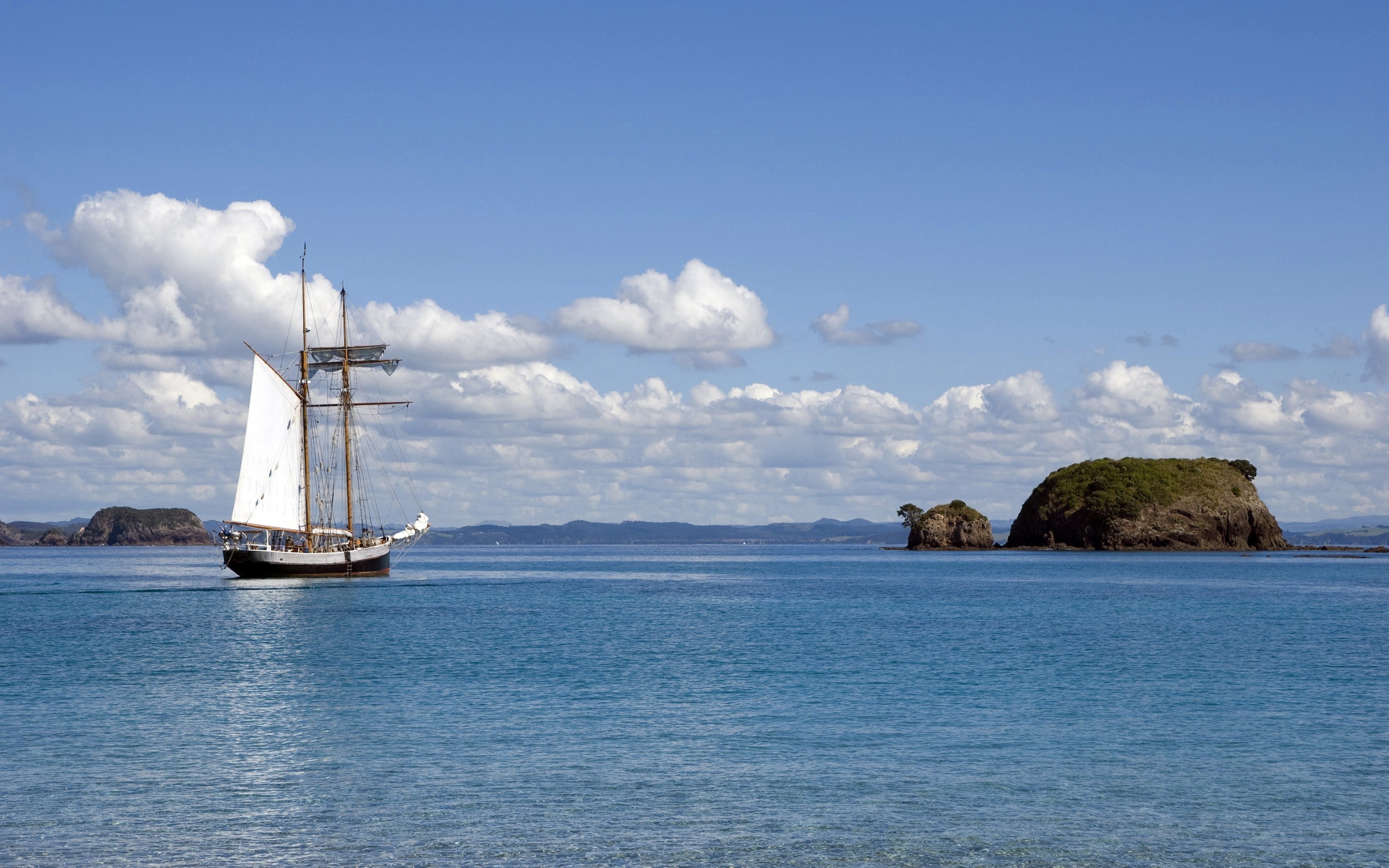 Sailing ship on the sea near islands HD Wallpaper