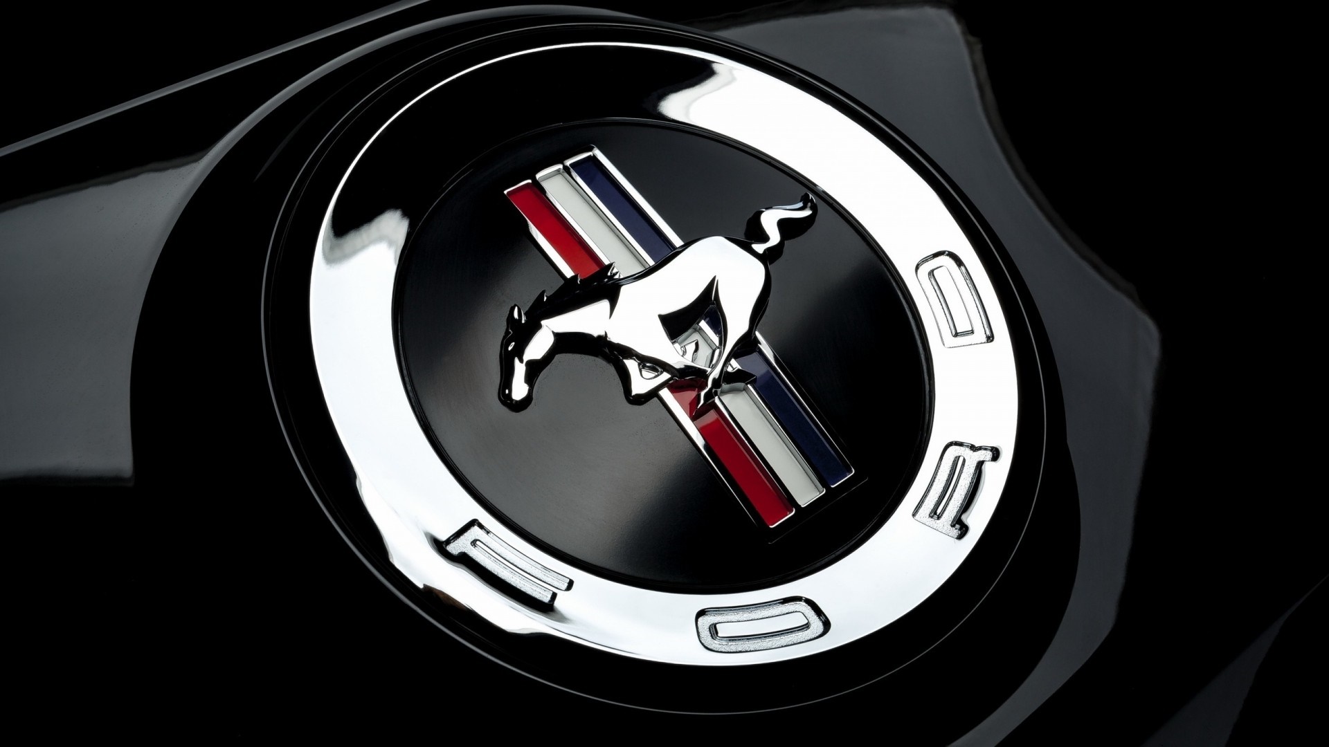 Ford Mustang emblem on a black car HD Wallpaper