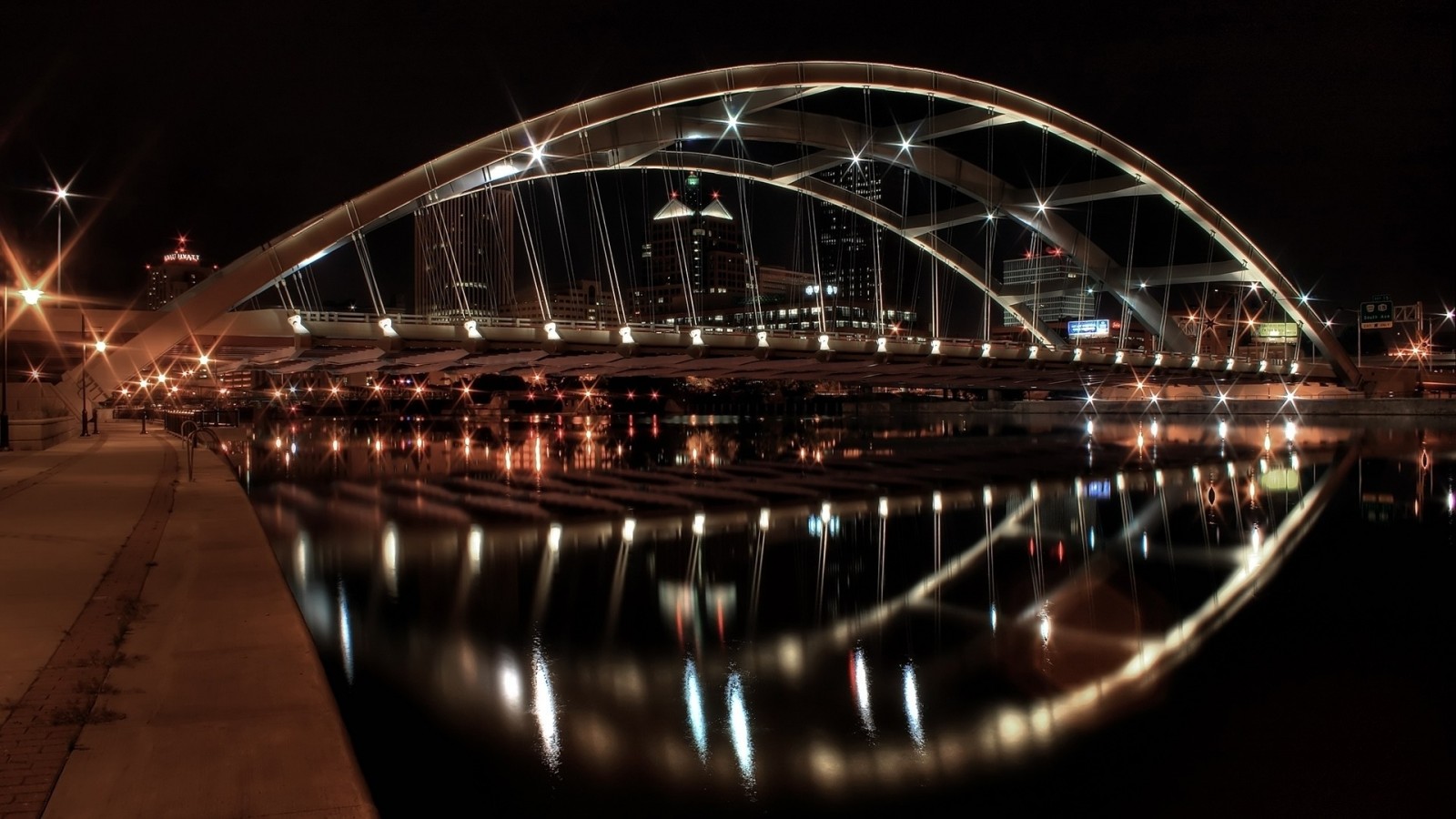 Night view of a modern bridge over a river with city lights HD Wallpaper