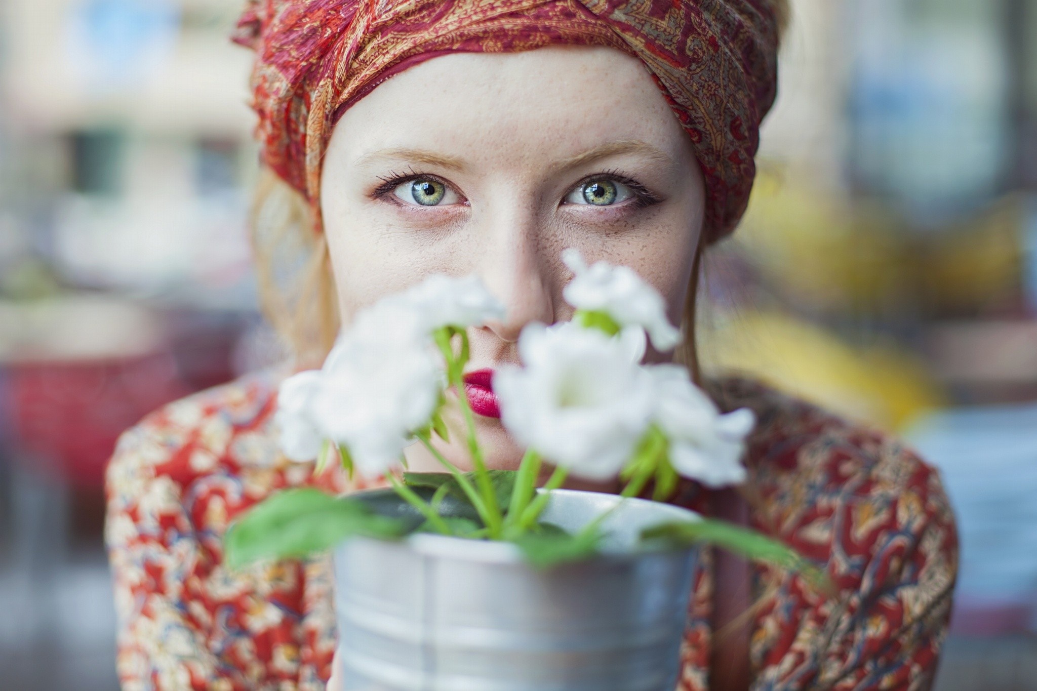 Woman with red headscarf holding white flowers HD Wallpaper