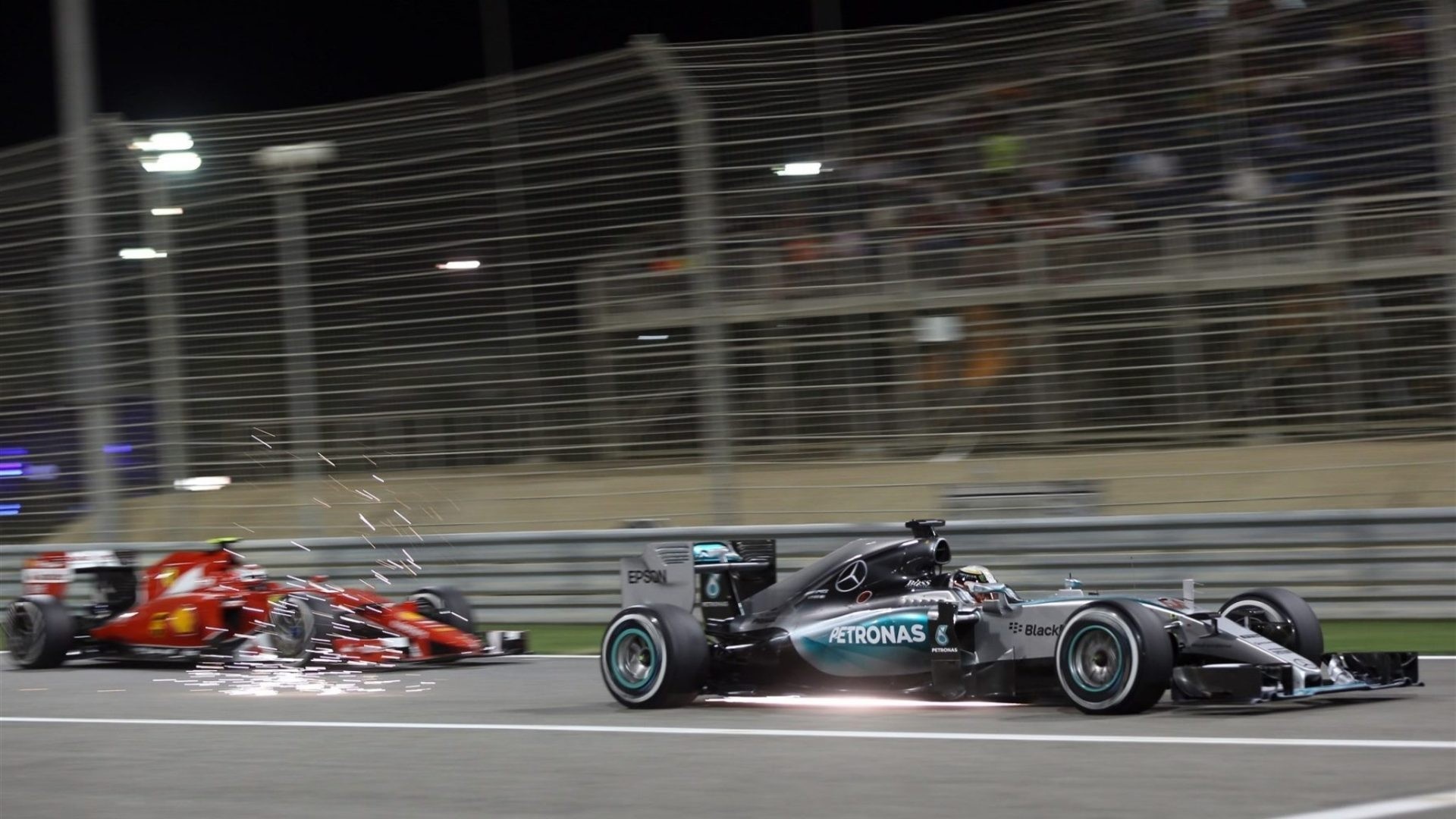 Formula 1 race cars on a track at night HD Wallpaper