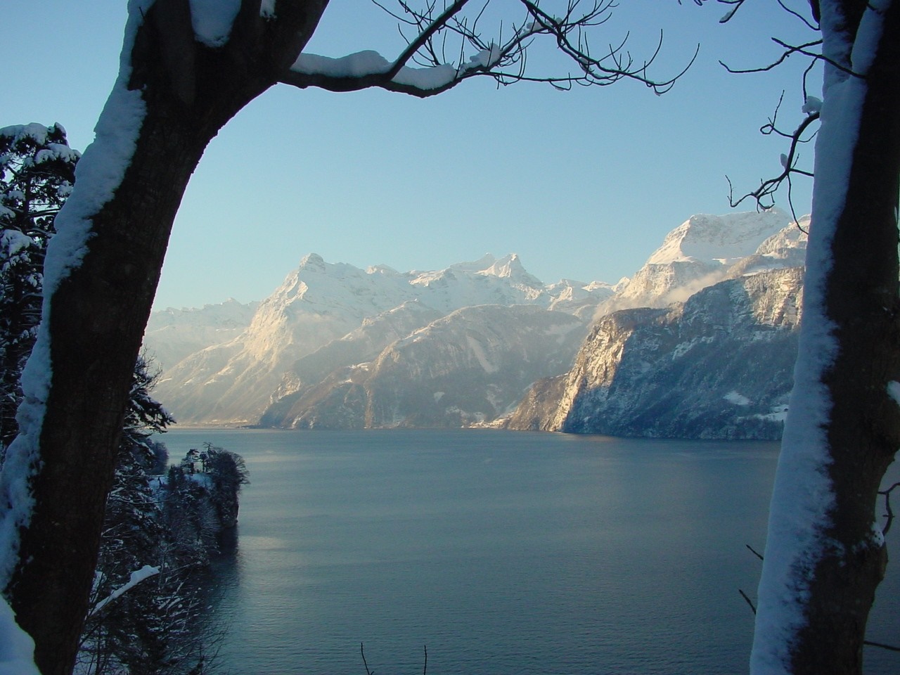 Snow-covered mountains and lake in winter HD Wallpaper