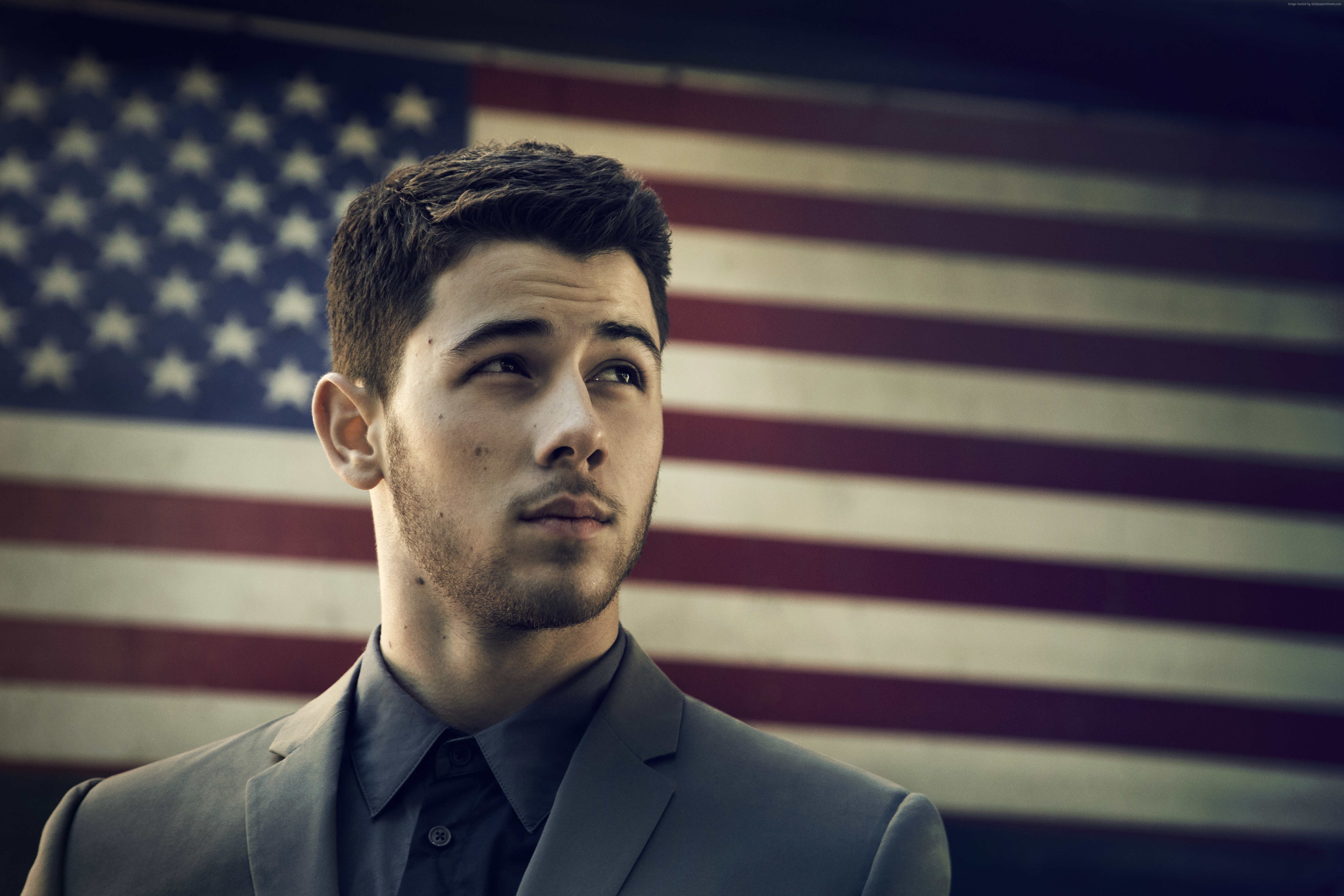 Nick Jonas in front of American Flag HD Wallpaper