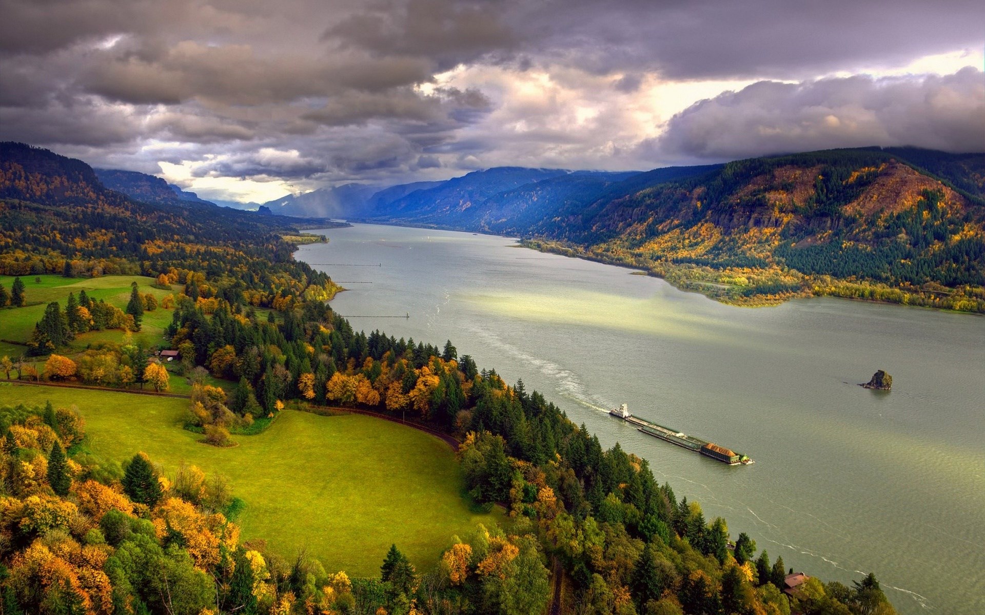 Barge on a wide river surrounded by autumn foliage and mountains HD Wallpaper