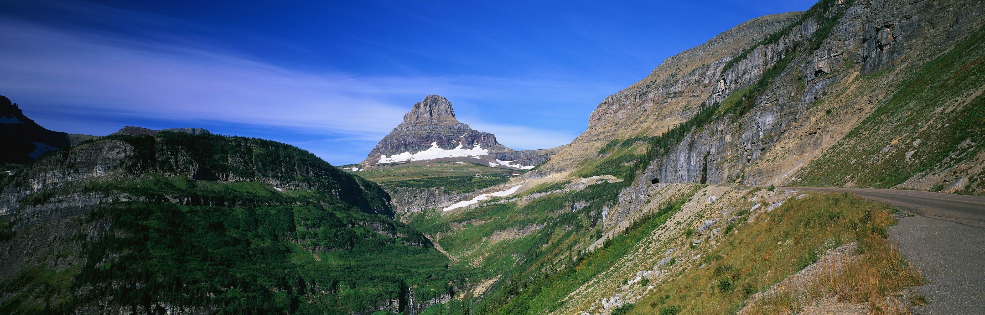 Panoramic view of a mountain valley with a prominent peak HD Wallpaper