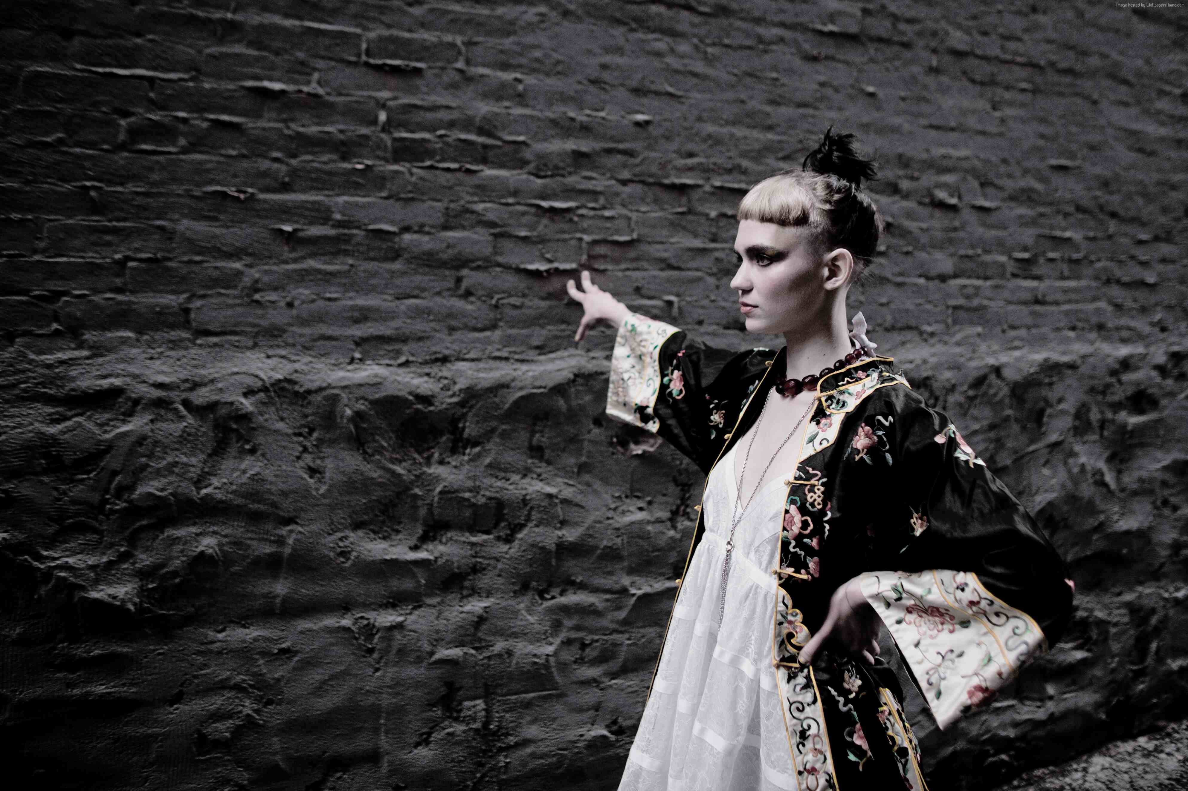 Grimes in ornate robe against brick wall HD Wallpaper