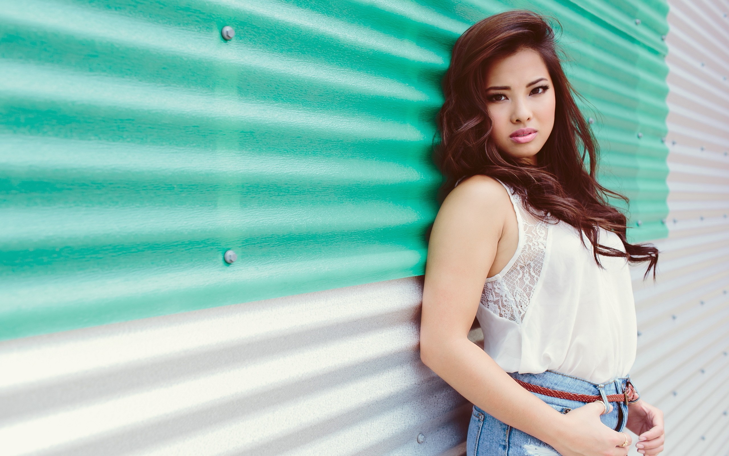 Asian woman leaning against a corrugated metal wall HD Wallpaper