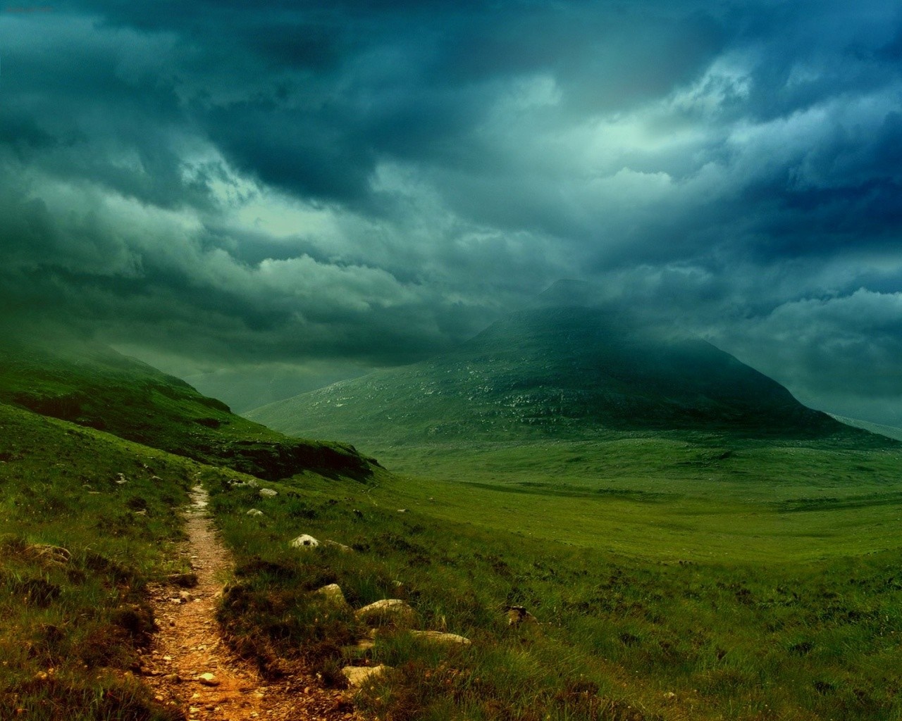 Mountain valley with a path under stormy clouds HD Wallpaper