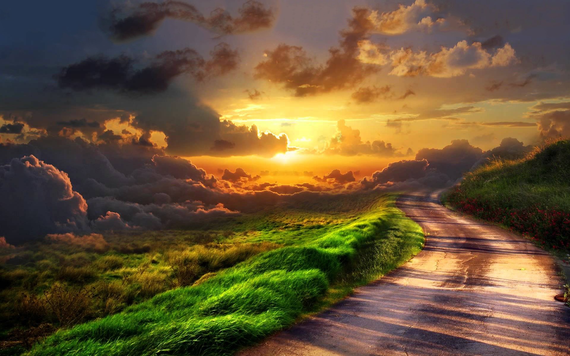 Road through a grassy hill at sunset with clouds HD Wallpaper